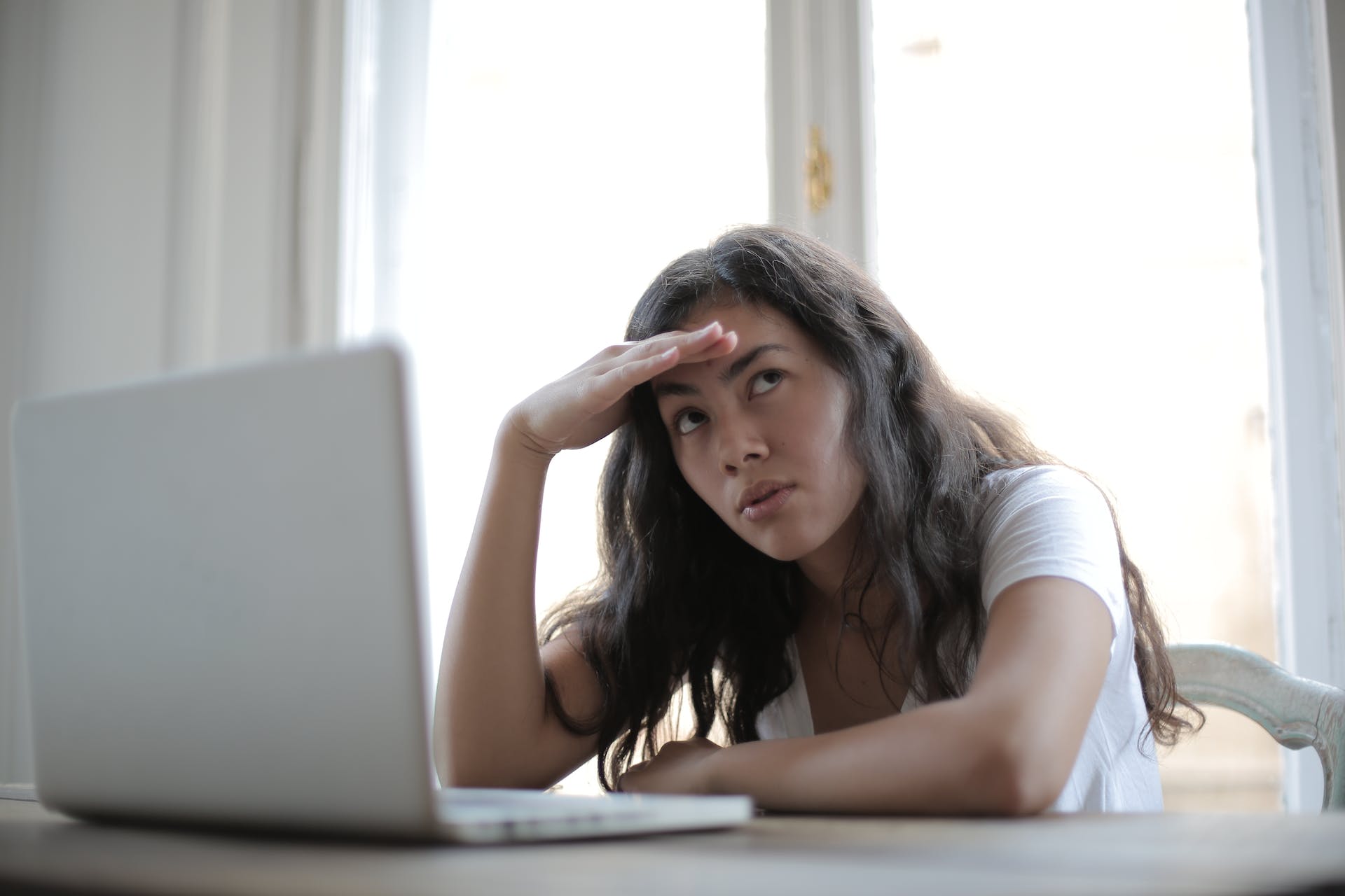 An annoyed woman at the laptop. 