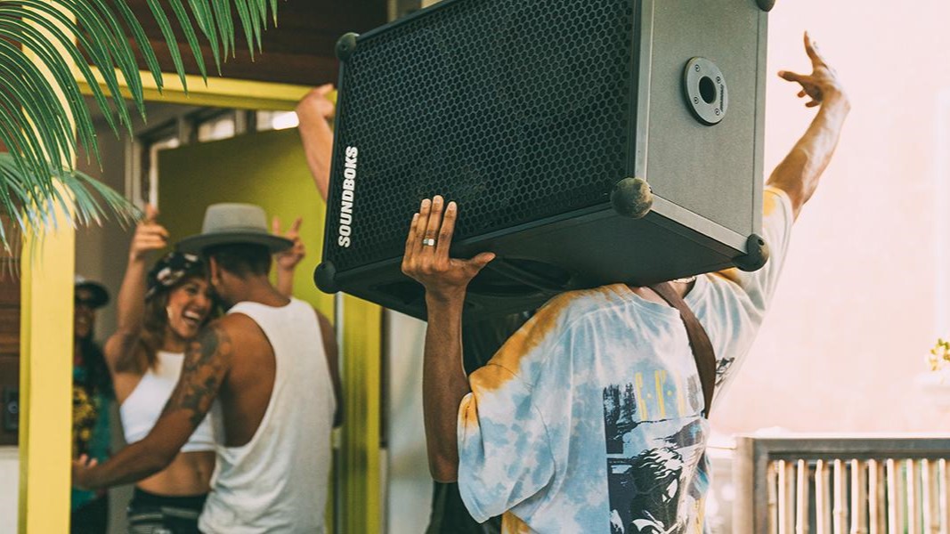 a man carrying the soundboks 4 speaker