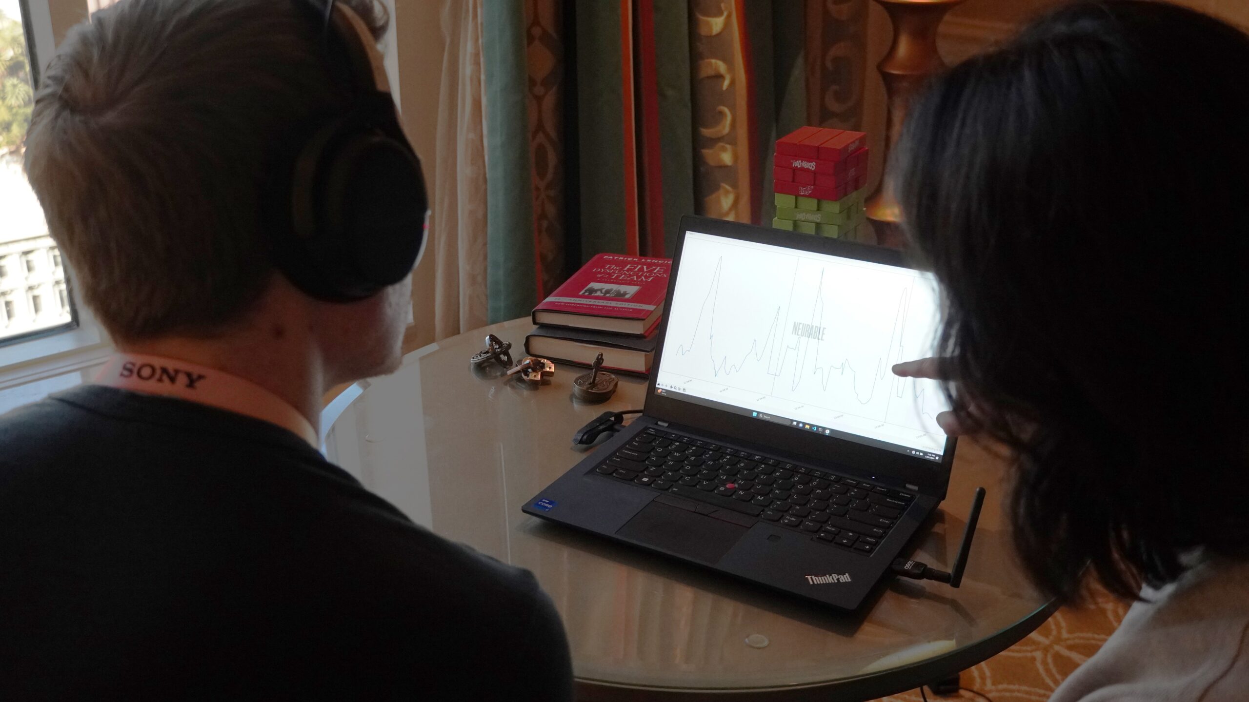 Adam looking at Neurable brain-tracking data while wearing the MW75 Neuro headphones