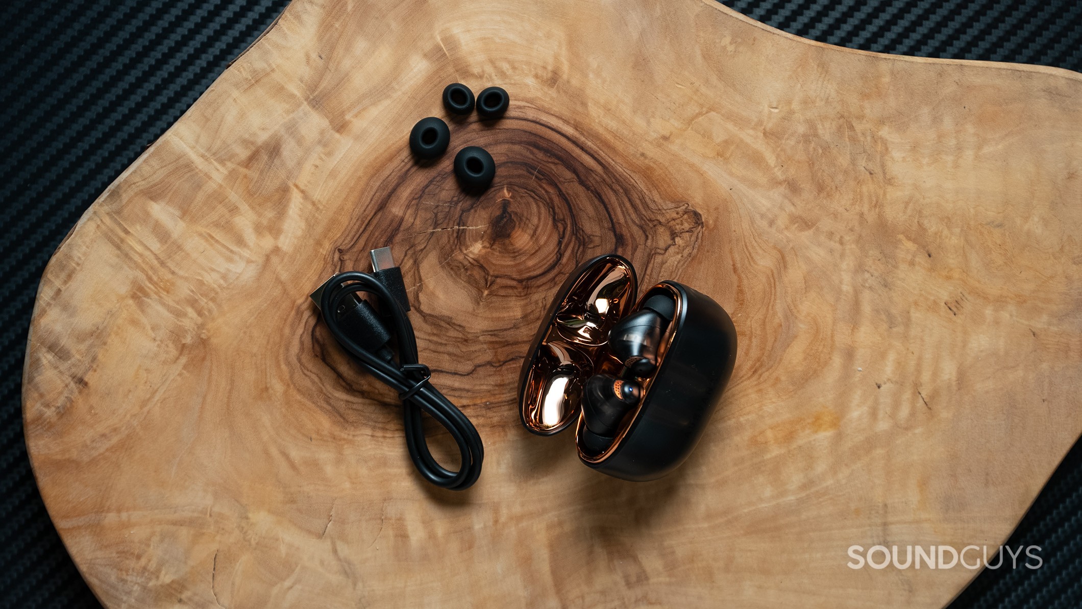 Creative Aurvana Ace 2 with ear tips and charging cable.