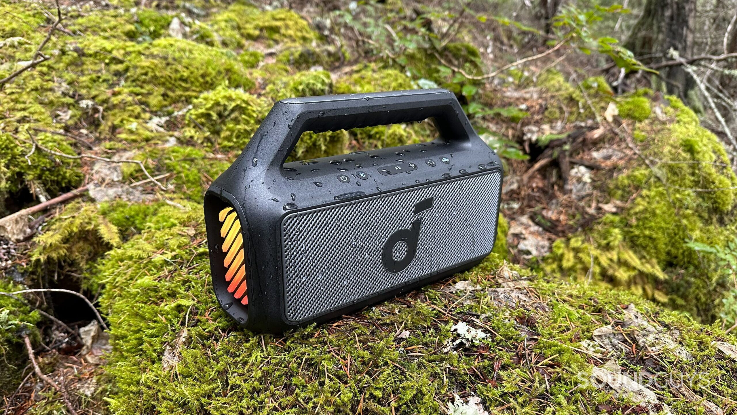 Side view of the Anker Soundcore Boom 2 on a mossy rock.