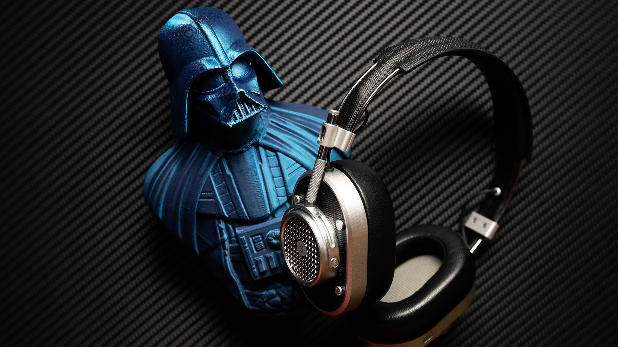 Master &amp; Dynamic MH40 headphones next to a figurine Darth Vader.