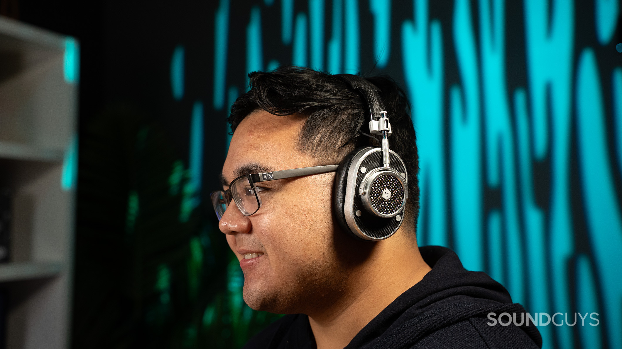 A man wearing the Master &amp; Dynamic MH40 headphones with the left side of his head visible. 