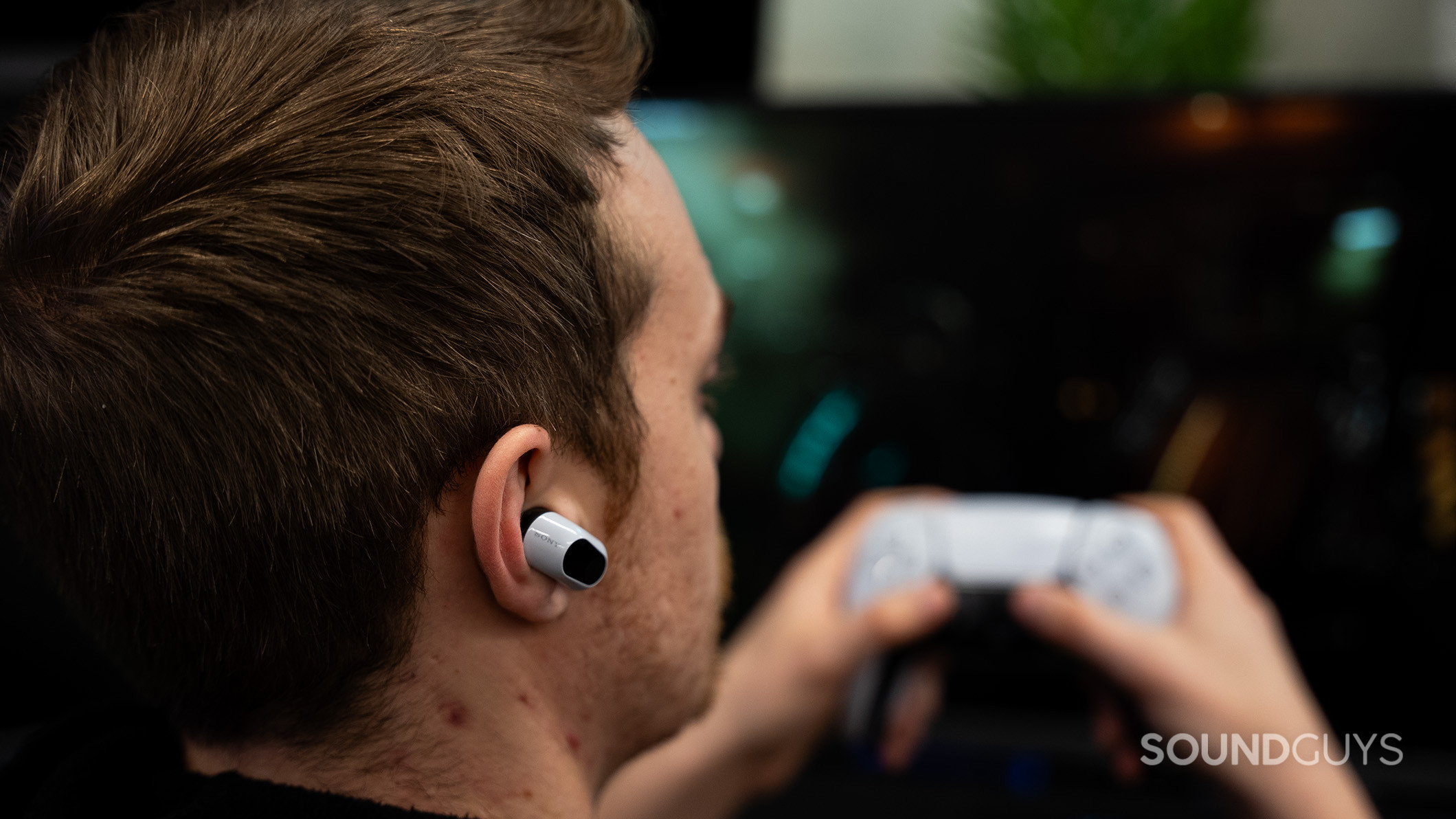 A man wearing the Sony INZONE Buds while gaming.