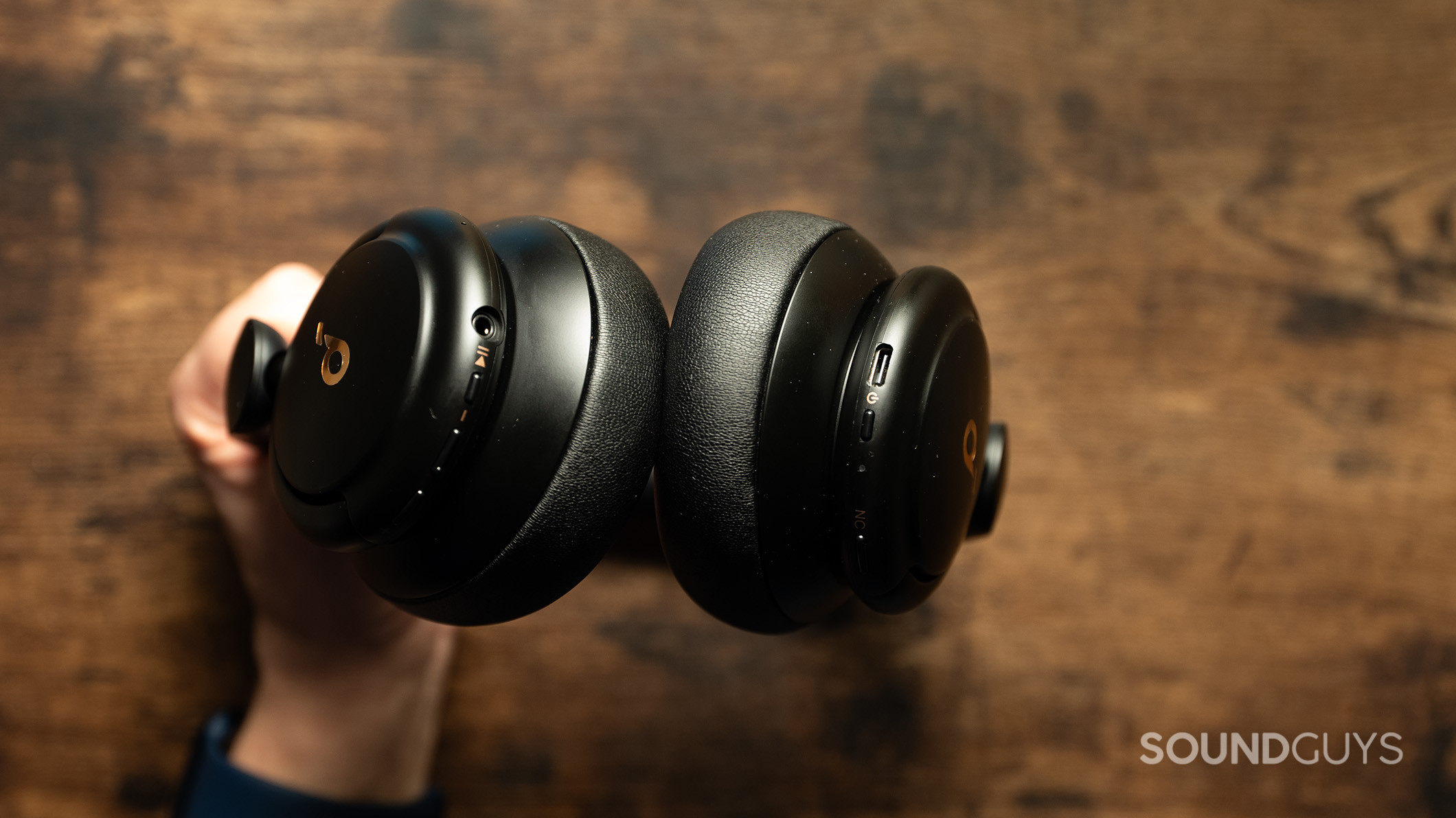 A hand holds the Anker Soundcore Life Q30 headphones.