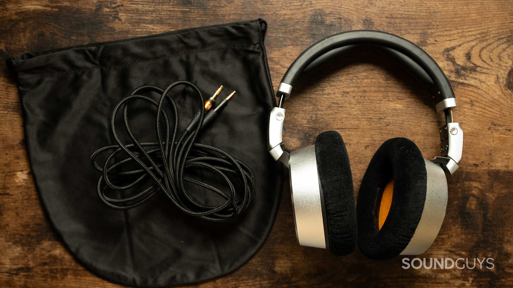 Neumann NDH 30 headphones next to their case and cable.