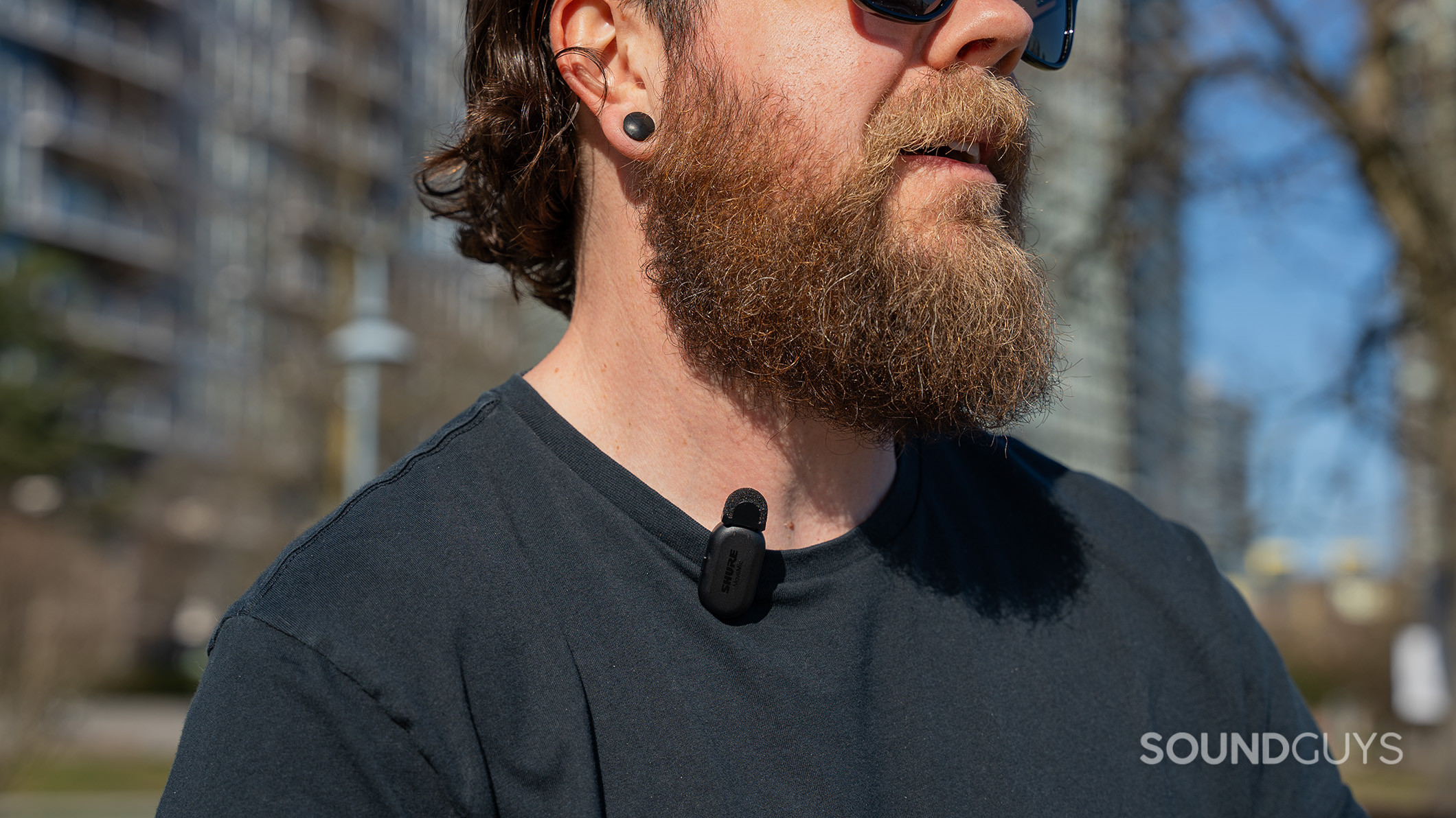 Shure MoveMic Two downtown Photo of a man wearing a Shure MoveMic transmitter