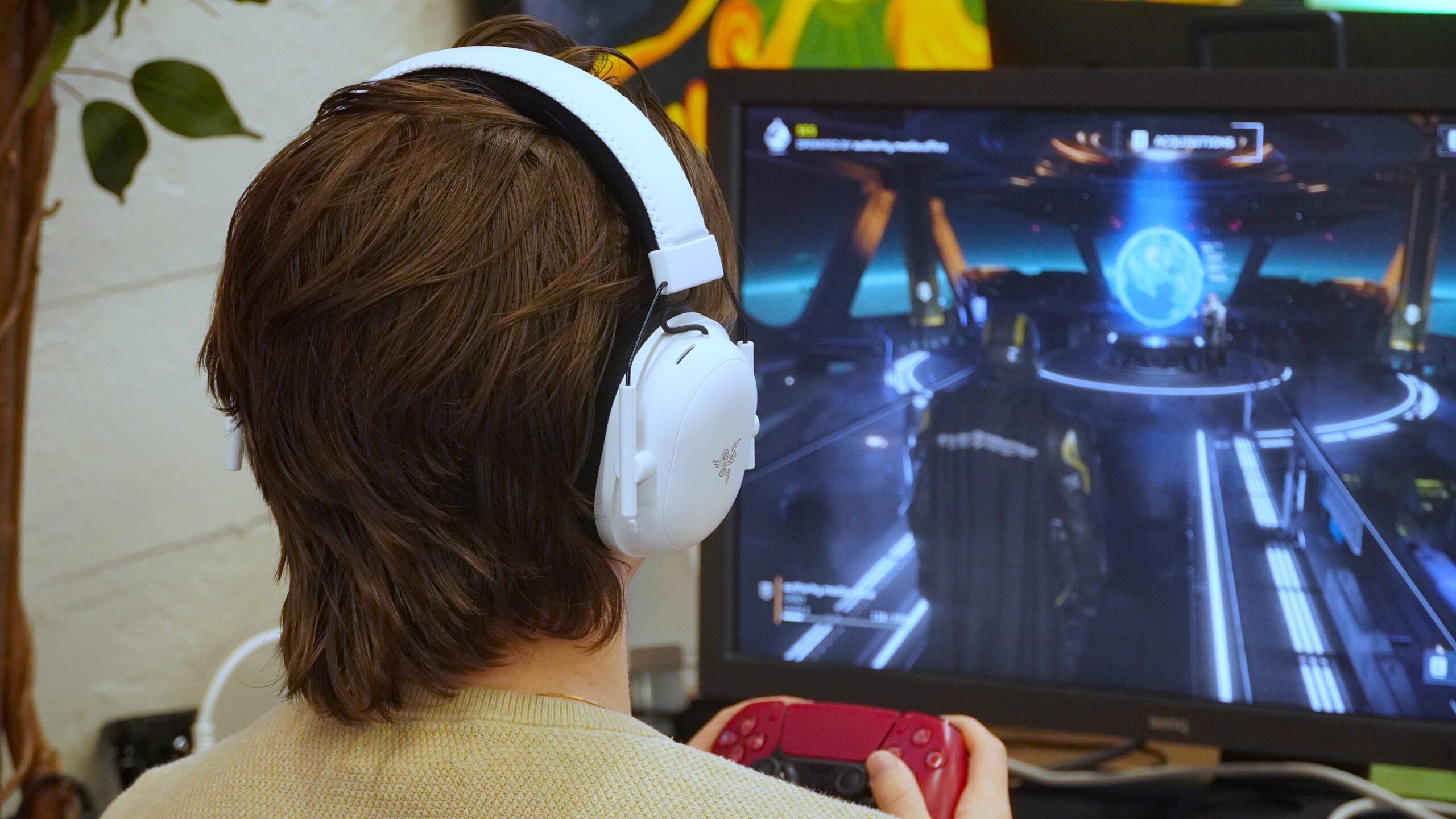 A man wearing the Razer BlackShark V2 Pro while gaming