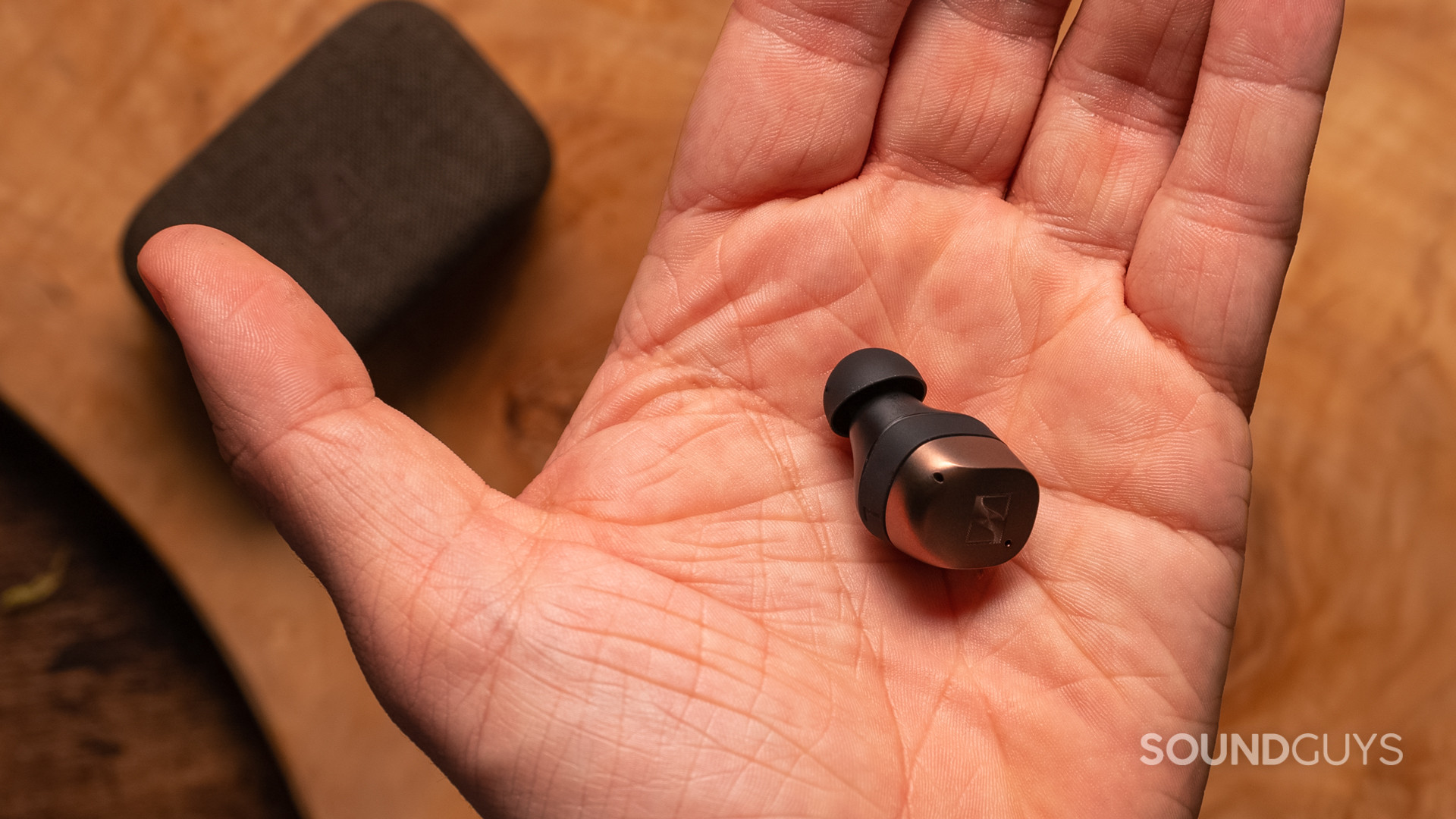 The individual earbud of the Sennheiser MOMENTUM True Wireless 4 in a hand.