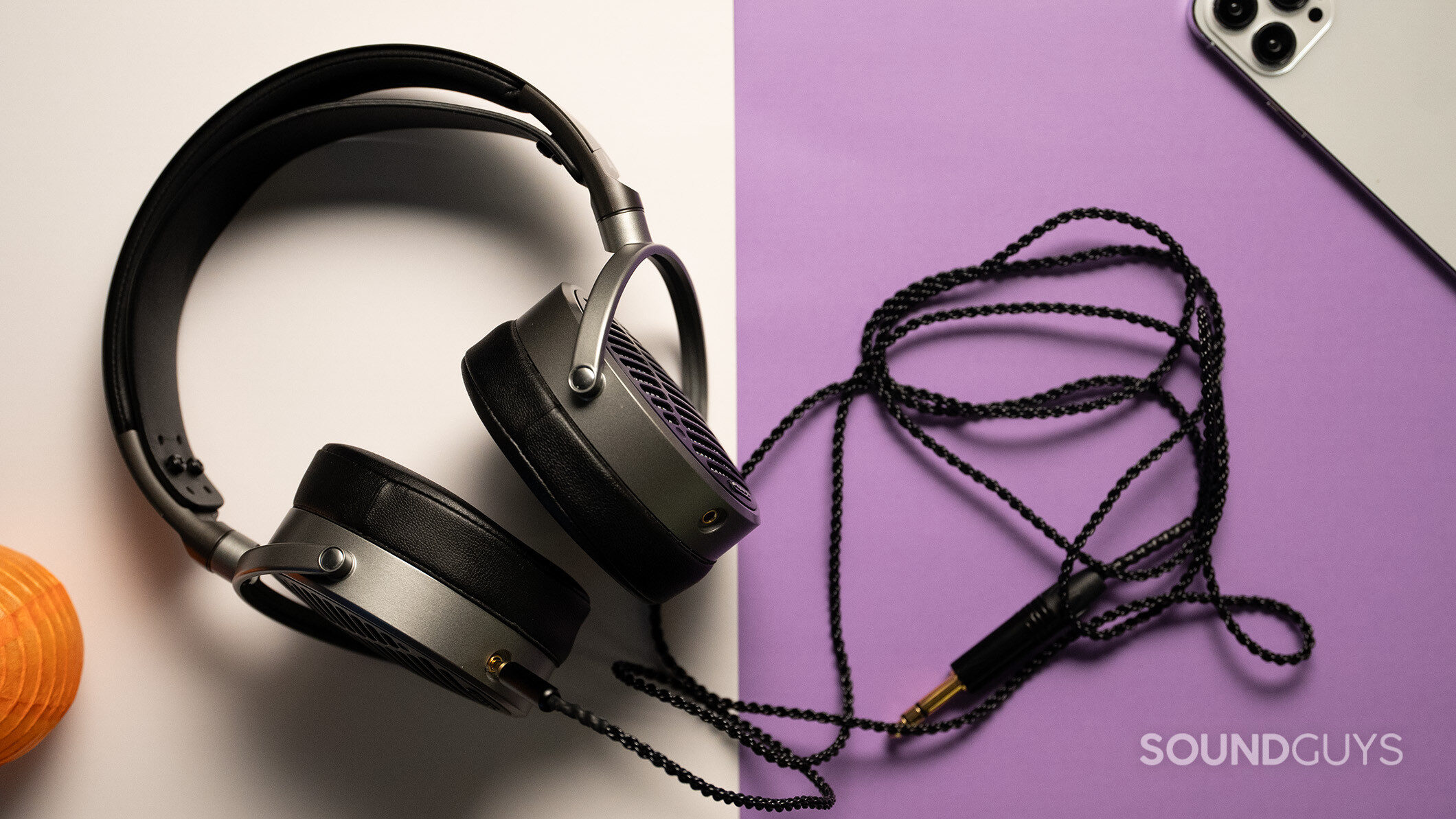 Audeze MM-100 headphones on a white and purple table. 