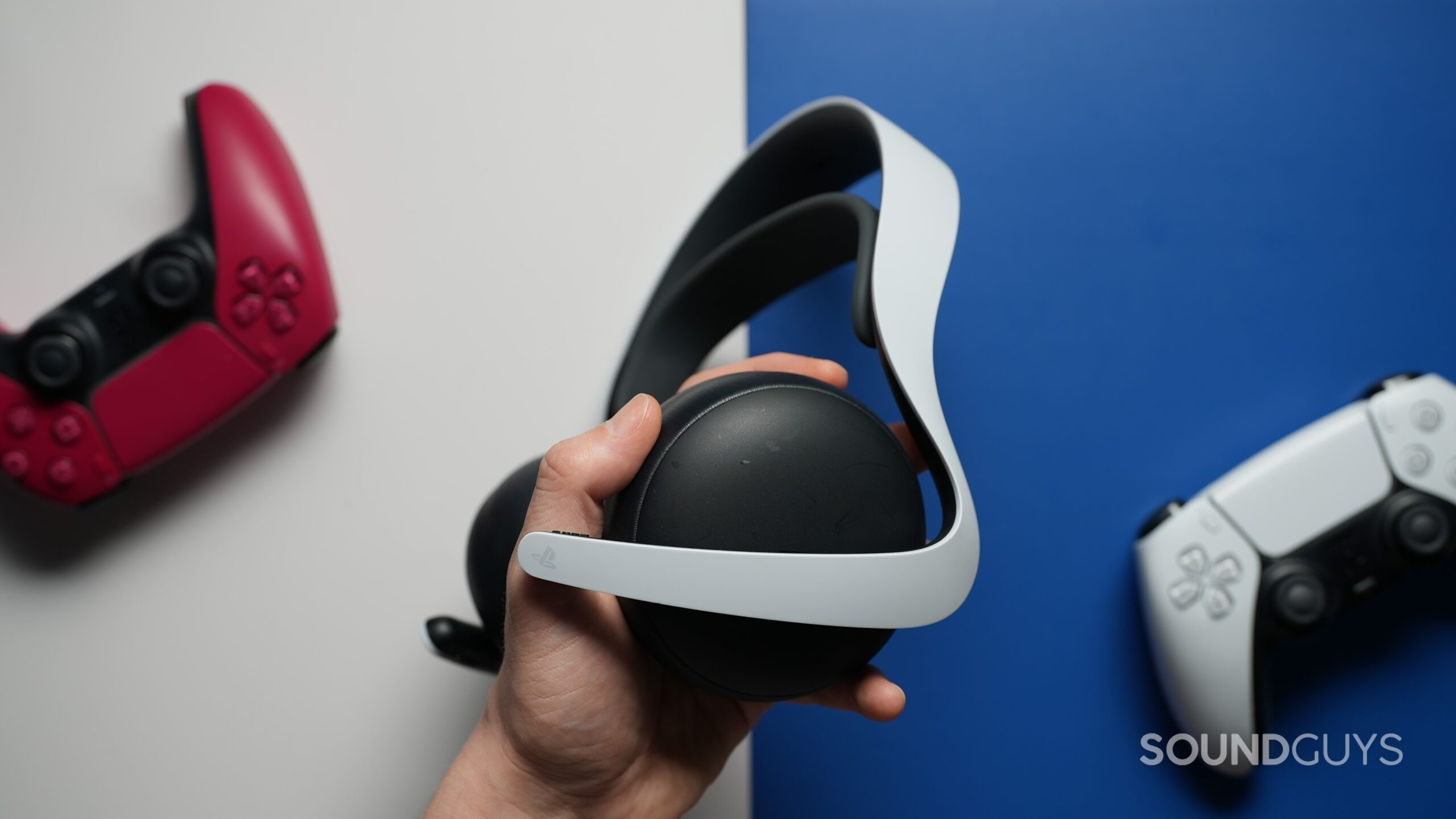 A hand holding the PlayStation Pulse Elite headset