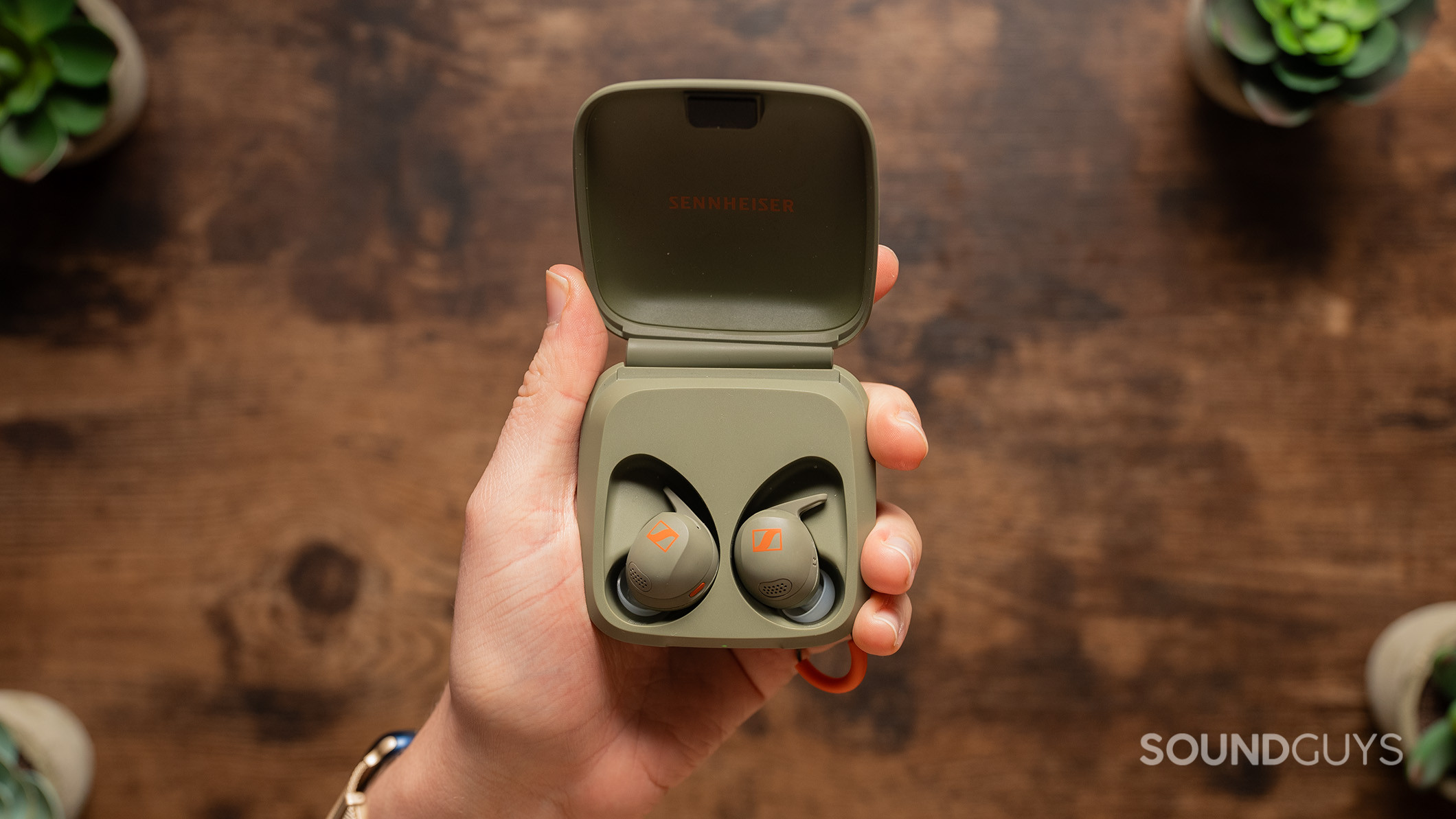 Sennheiser MOMENTUM Sport earbuds in charging case.