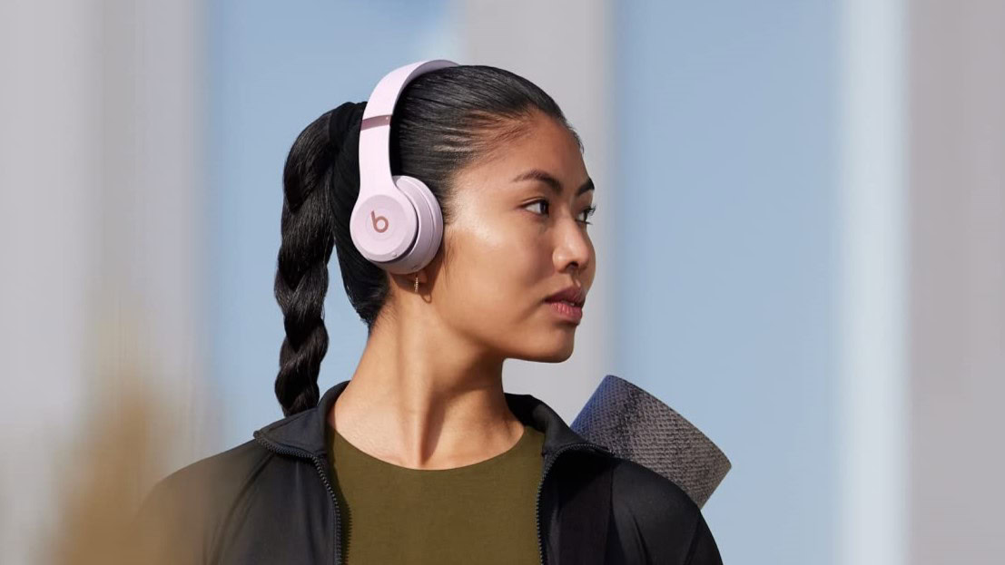 a women wearing the beats solo 4 headphones