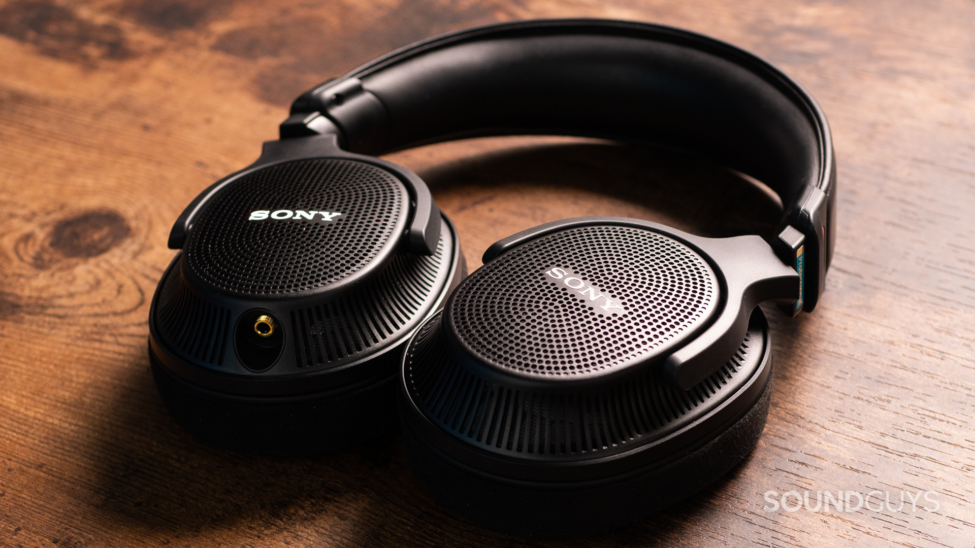 A photo of the Sony MDR-MV1 sitting flat on a wooden desk.