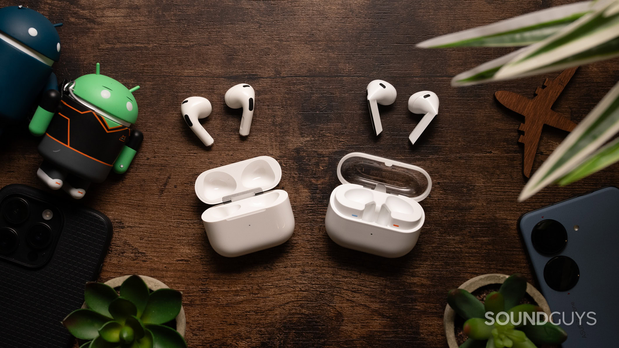 Samsung Galaxy Buds3 vs Apple AirPods (3rd generation) earbuds outside case Samsung Galaxy Buds3 on a table next to Apple AirPods (3rd generation).