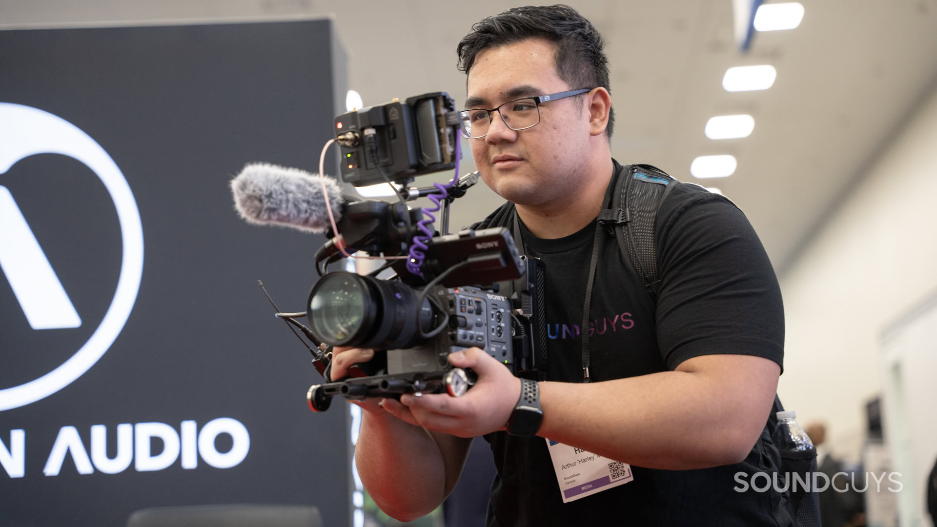 A man using a professional setup to record with a camera.