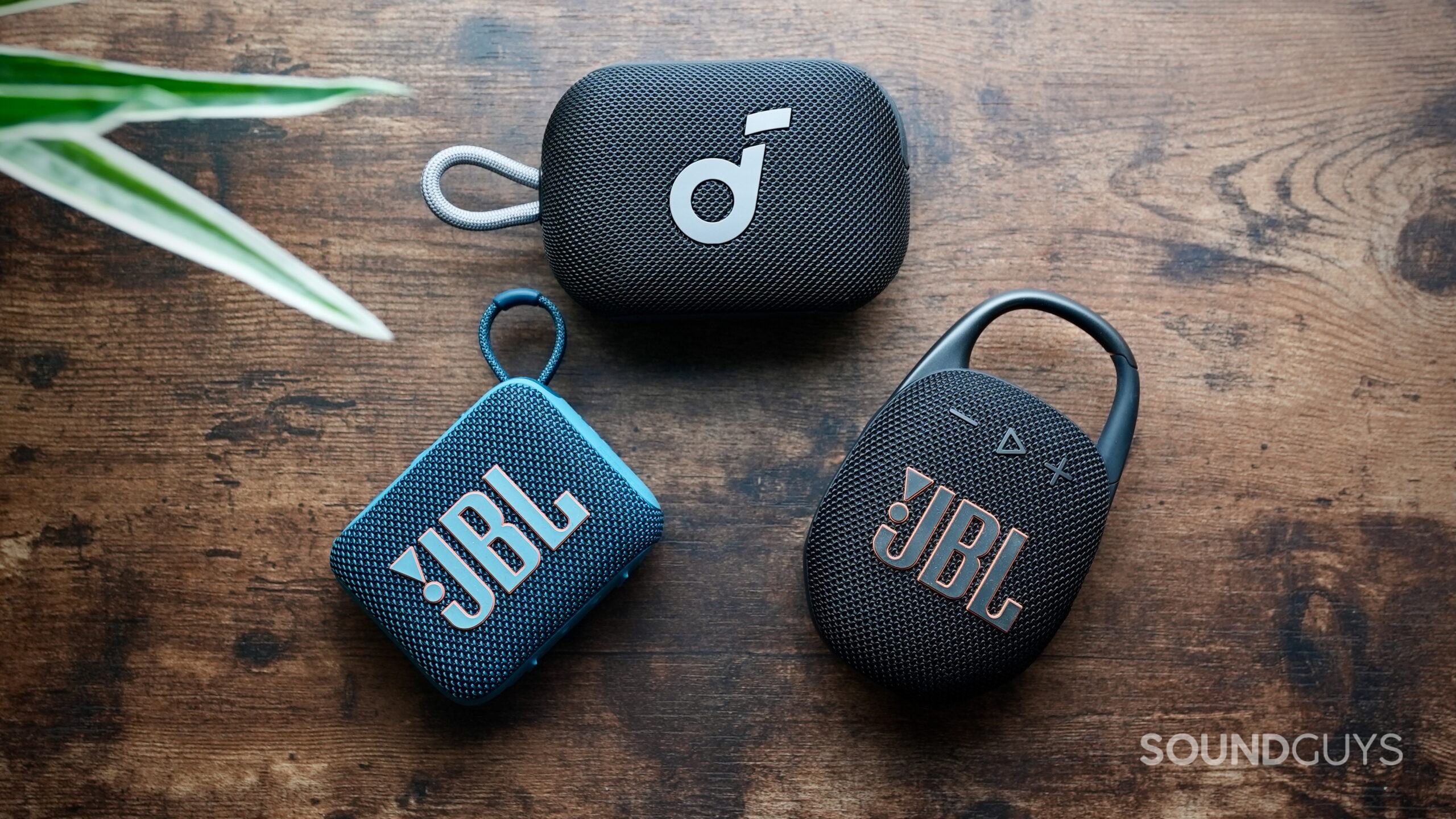 Select 4 Go - 2 (1) Top down photo of a JBL Go 4, Soundcore Select 4 Go, and a JBL Clip 5.