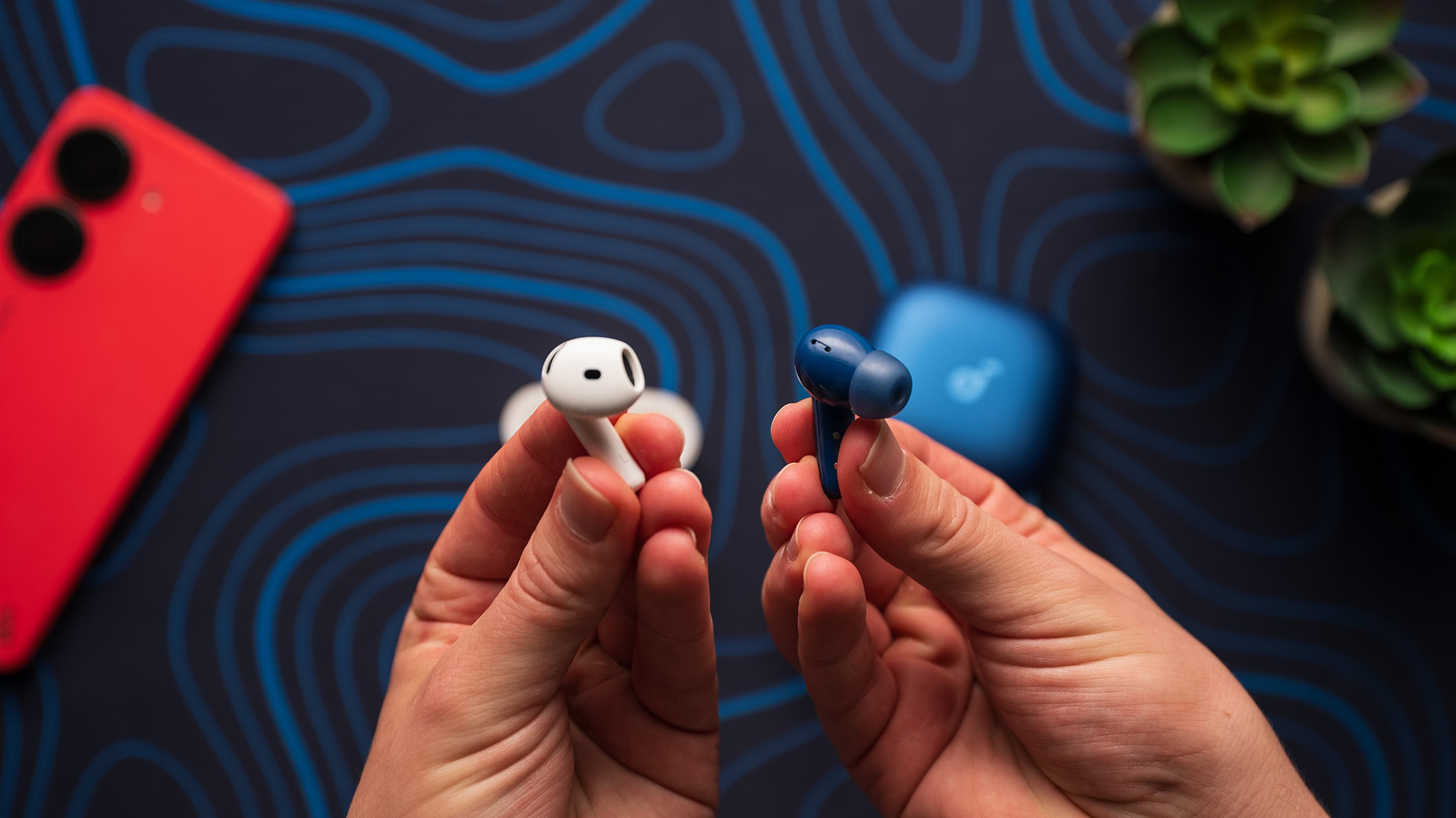 Anker Soundcore Liberty 5 next to Apple AirPods 4 eartips Anker Soundcore Liberty 5 earbud next to an Apple AirPods 4 earbud.