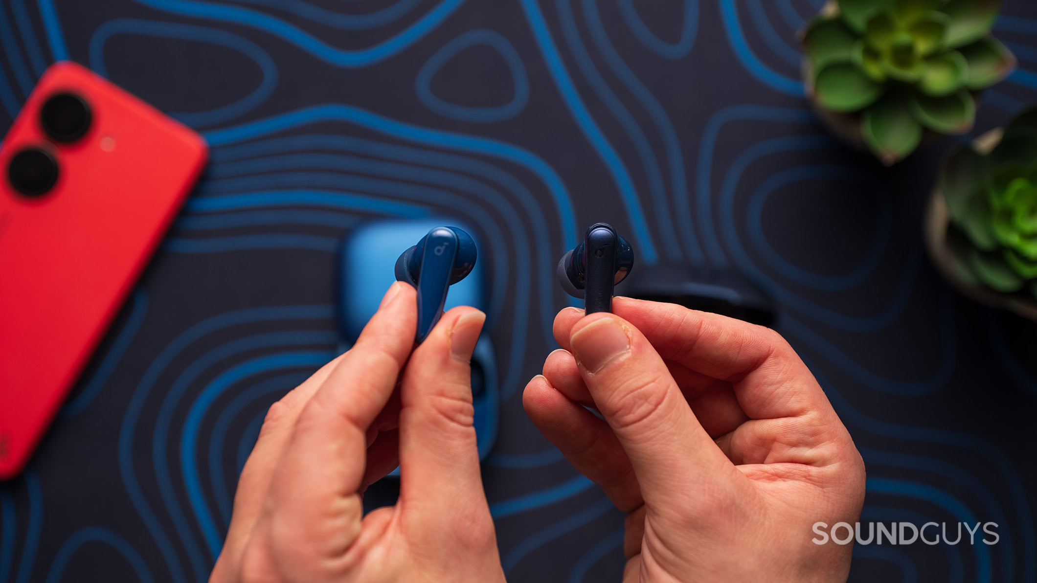Anker Soundcore Liberty 5 next to Liberty 4 NC earbud Anker Soundcore Liberty 5 earbud next to a Liberty 4 NC earbud.
