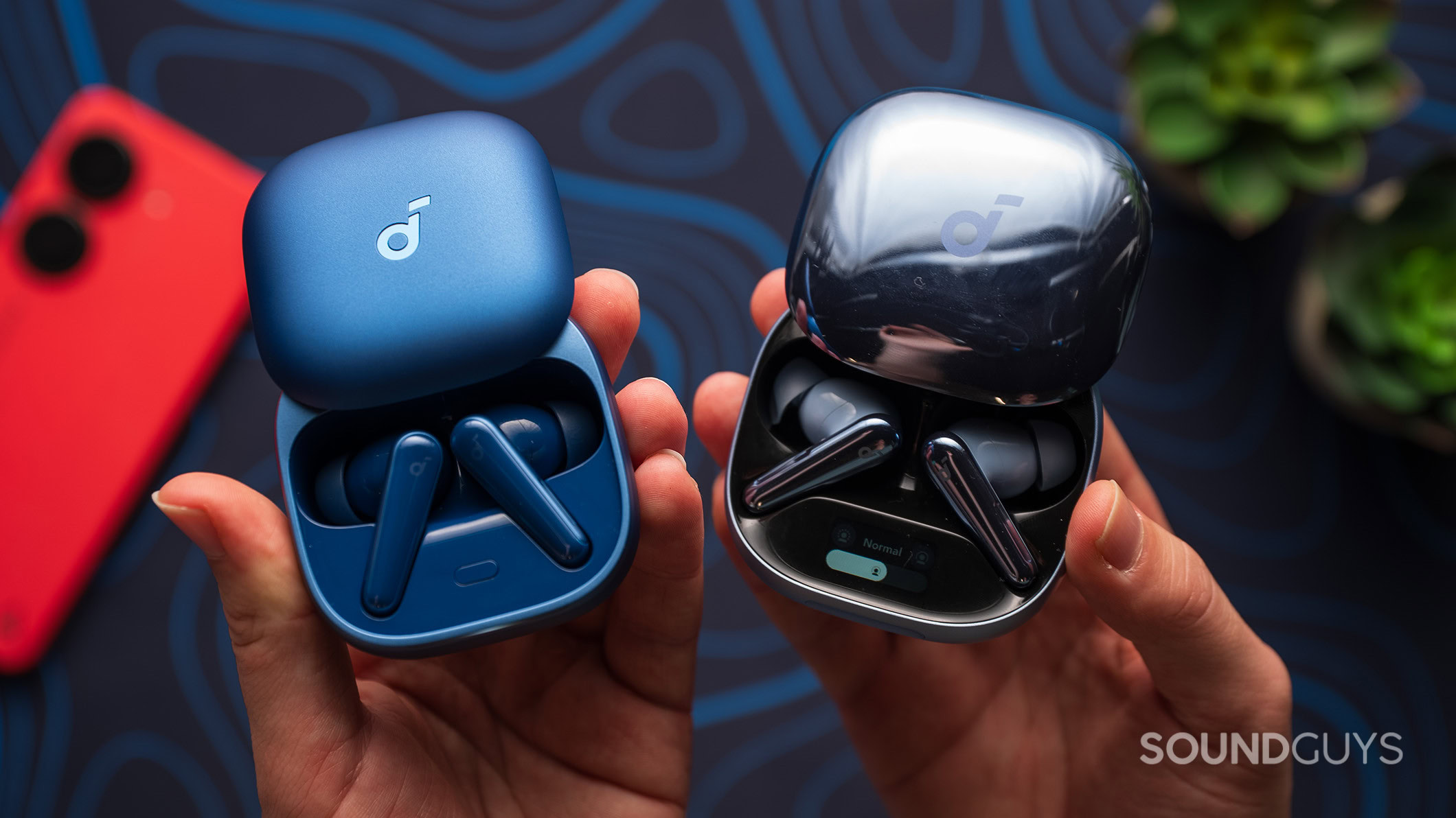 Anker Soundcore Liberty 5 next to Liberty 4 Pro Hands holding the Anker Soundcore Liberty 5 and Liberty 4 Pro earbuds.