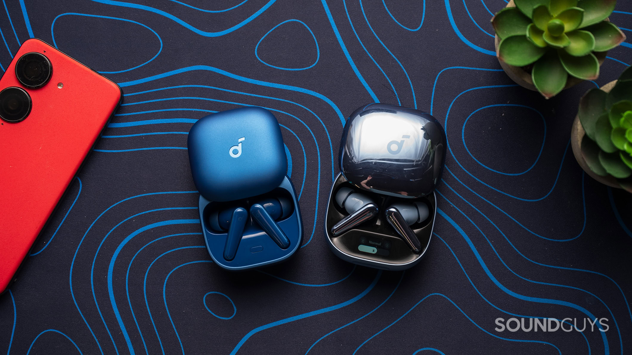 Anker Soundcore Liberty 5 next to Liberty 4 Pro case Anker Soundcore Liberty 5 next to Liberty 4 Pro earbuds on a table.