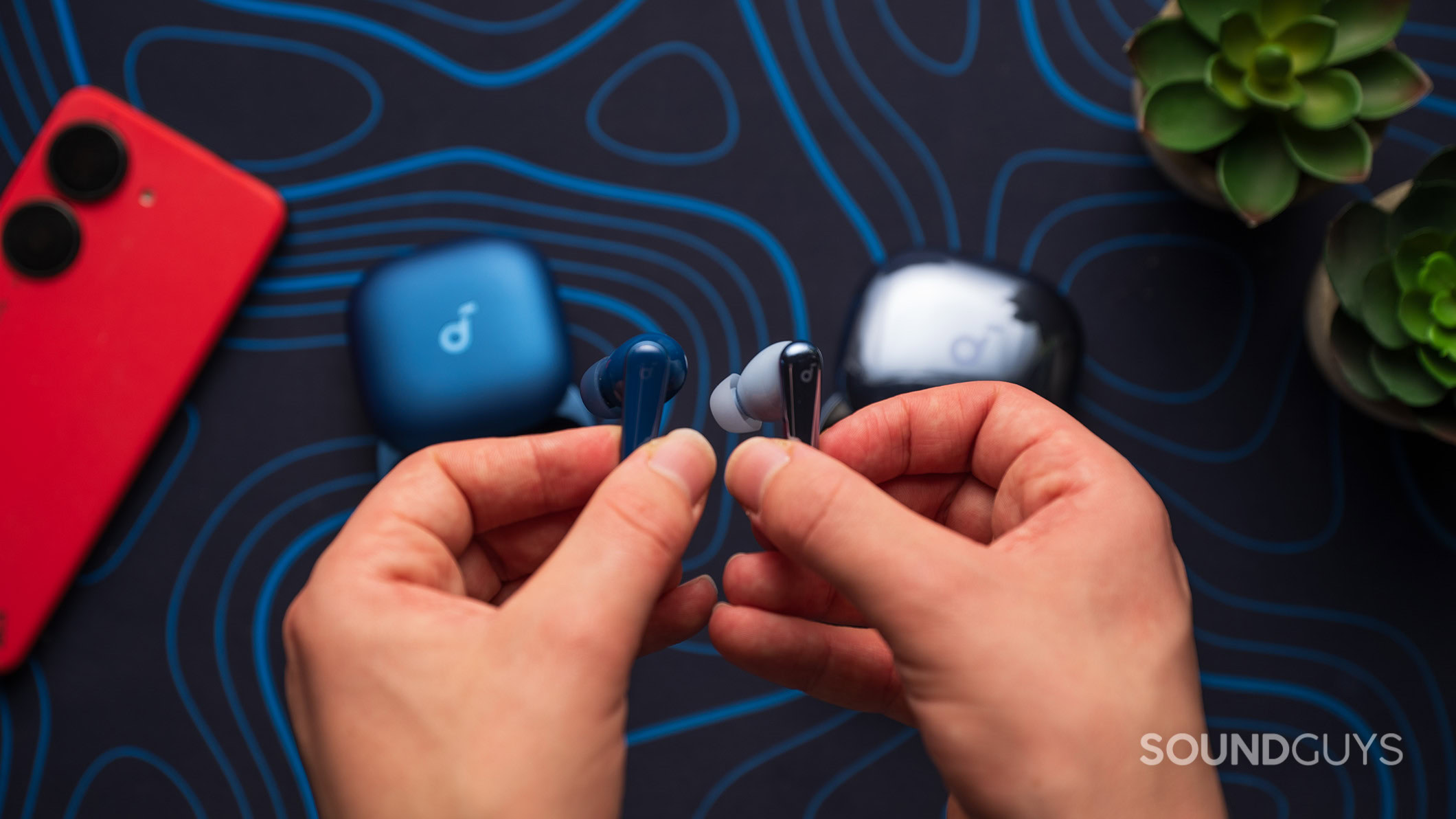Anker Soundcore Liberty 5 next to Liberty 4 Pro earbud A Liberty 5 earbud and a Liberty 4 Pro earbud held in hand.