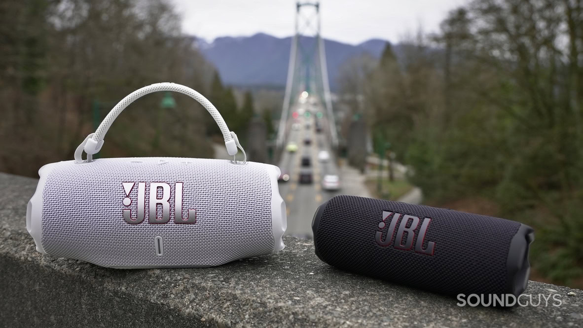 B39782DC-A8BC-4AFD-8719-E6B3A9B1E87A_1_105_c A JBL Charge 6 and Flip 7 placed on a bridge with another bridge in the background.