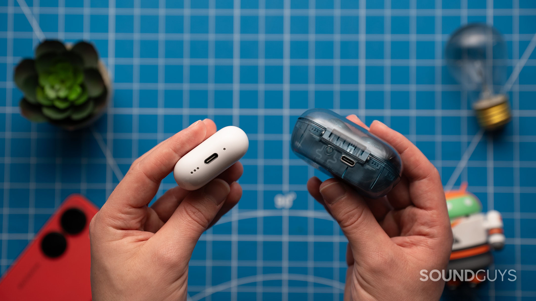 Sony WF-C710N and AirPods 4 charging port A hand holding an AirPods 4 case next to a hand holding a C710N case.