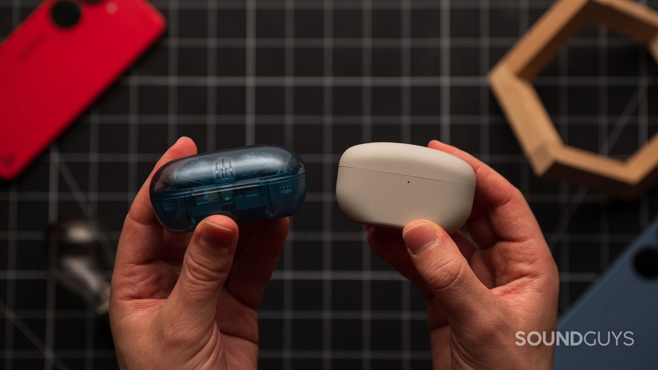 Sony WF-C710N vs Sony WF-1000XM5 cases Hands holding the Sony WF-C710N and Sony WF-1000XM5 earbud cases.