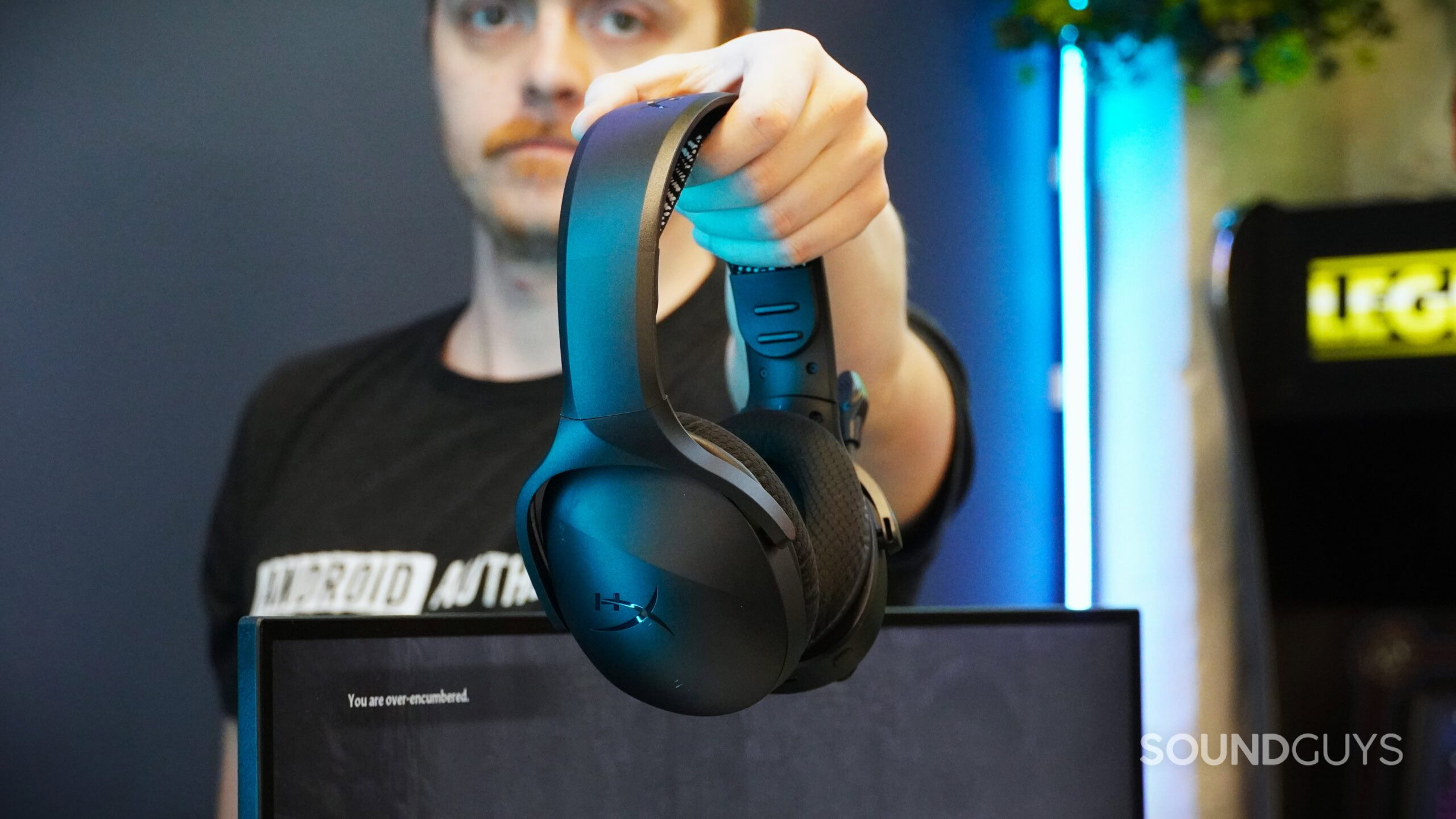 a man holding the hyperx cloud jet a man holding the hyperx cloud jet