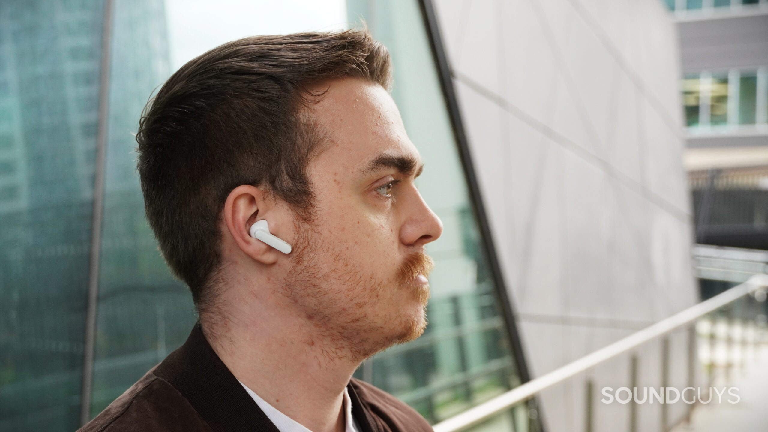 a man wearing the cmf buds 2 plus a man wearing the cmf buds 2 plus
