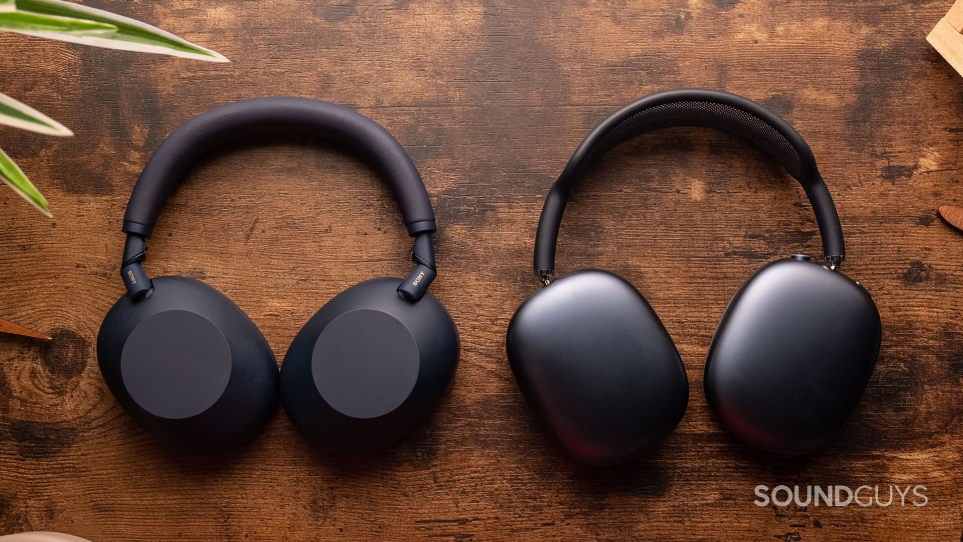 sony-wh-1000xm6-vs-apple-airpods-max Sony WH-1000XM6 next to AirPods Max on a table.