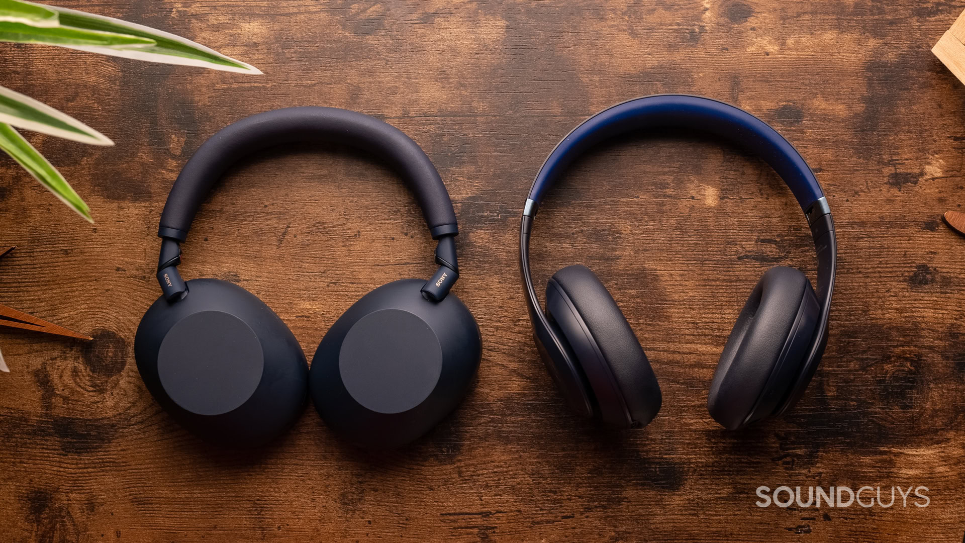 sony-wh-1000xm6-vs-beats-studio-pro Sony WH-1000XM6 next to Beats Studio Pro headphones on a table.