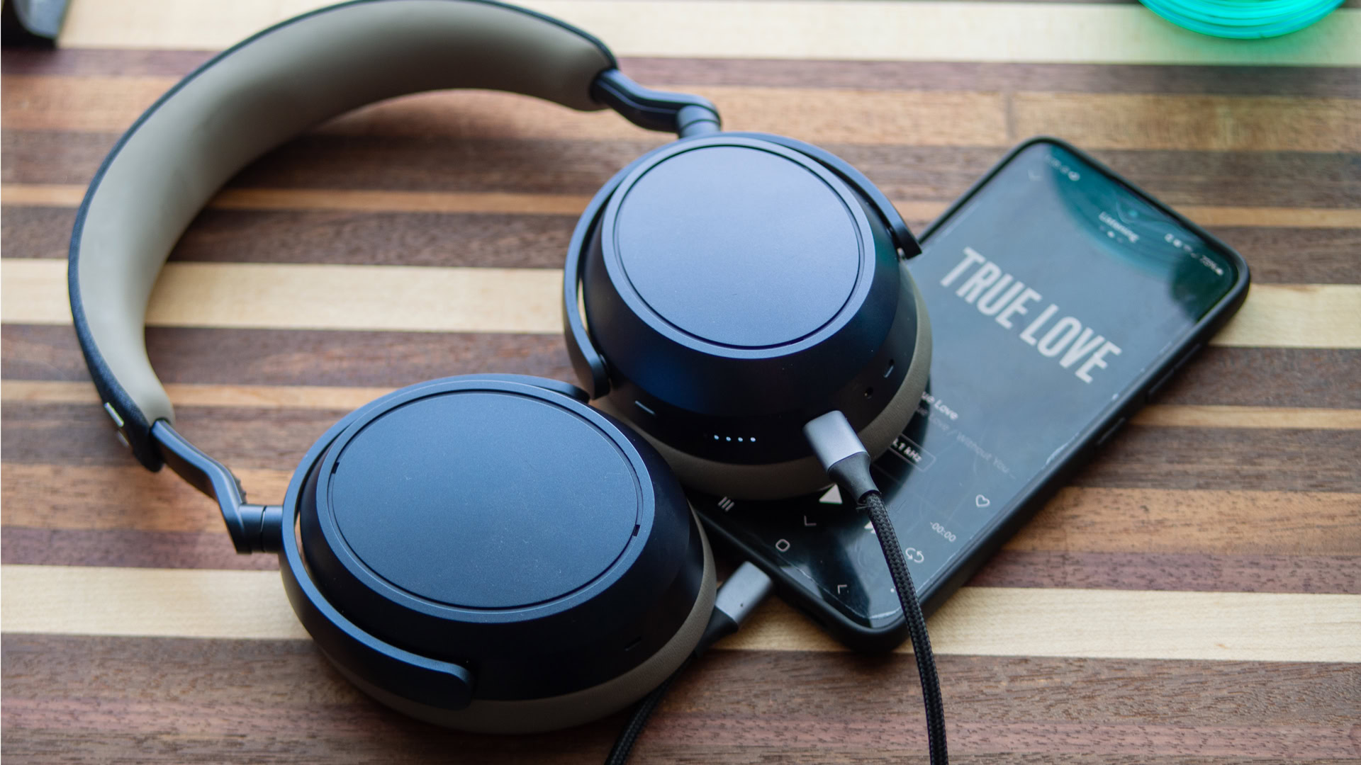 usb-hero A photo of the Sennheiser MOMENTUM 4 Wireless headphones connected to a smartphone with a USB-C cable.