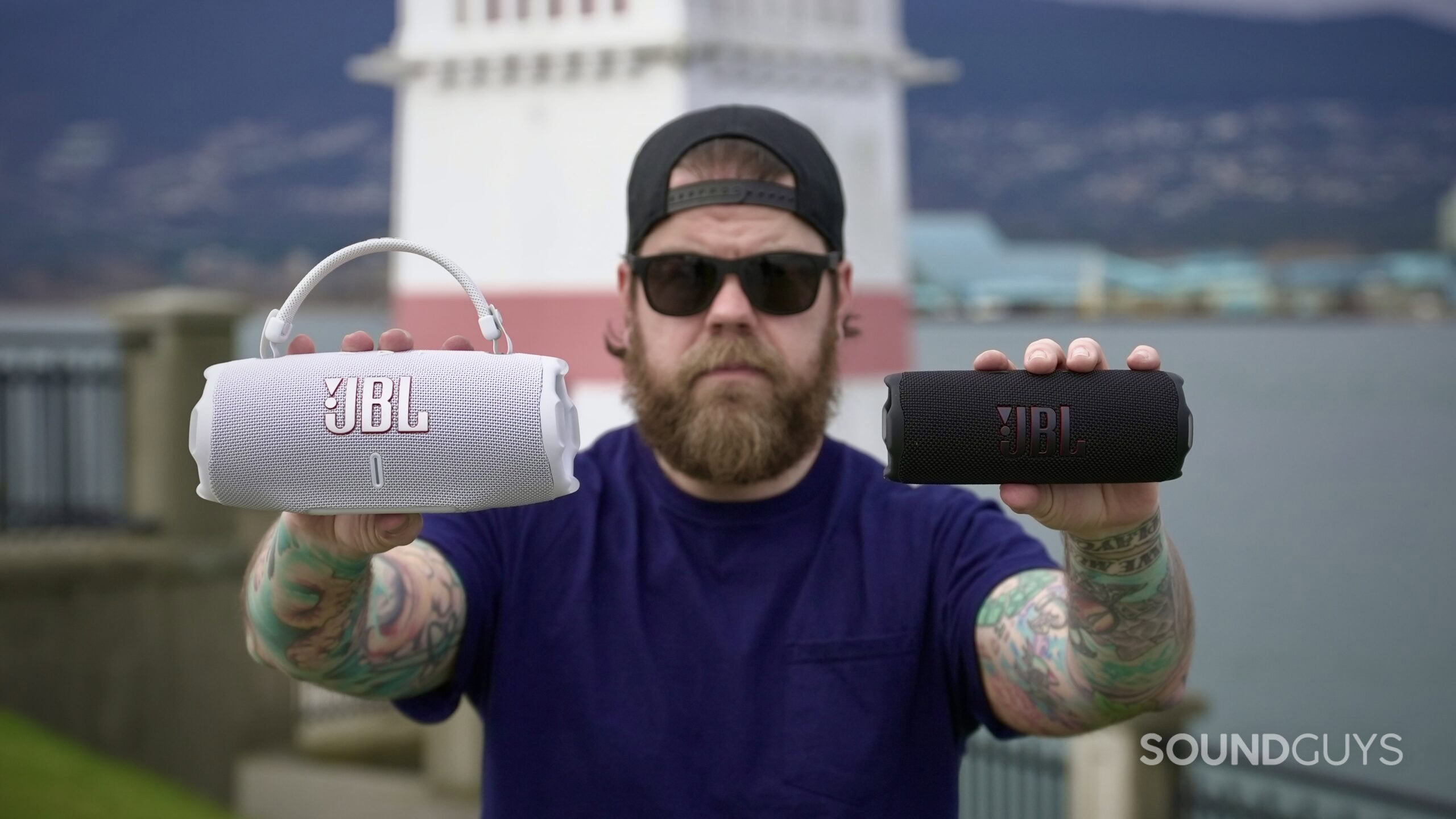 4DF60481-9B52-49E8-8DE5-30918C73CF43_1_201_a a man holding the JBL Charge 6 in one hand, and a Flip 7 in the other.