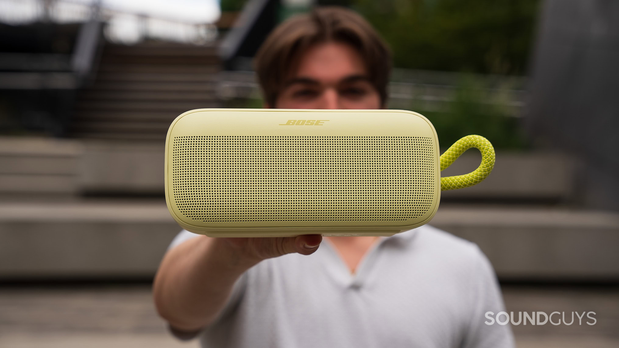 Bose SoundLink Plus held in hand A man holding the Bose SoundLink Plus in front of his face.