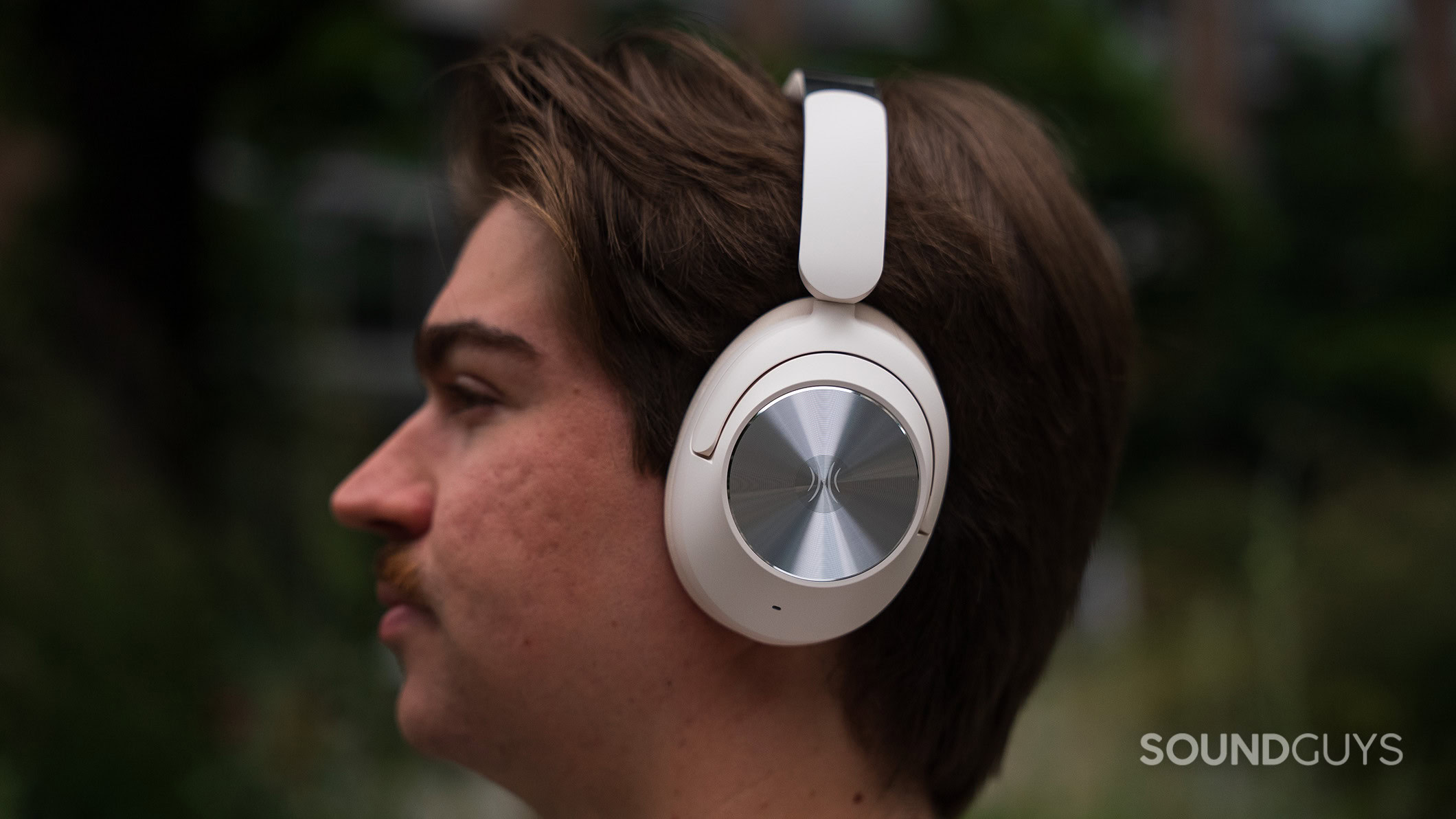 OneOdio Focus A6 headphones on a man's head outside.