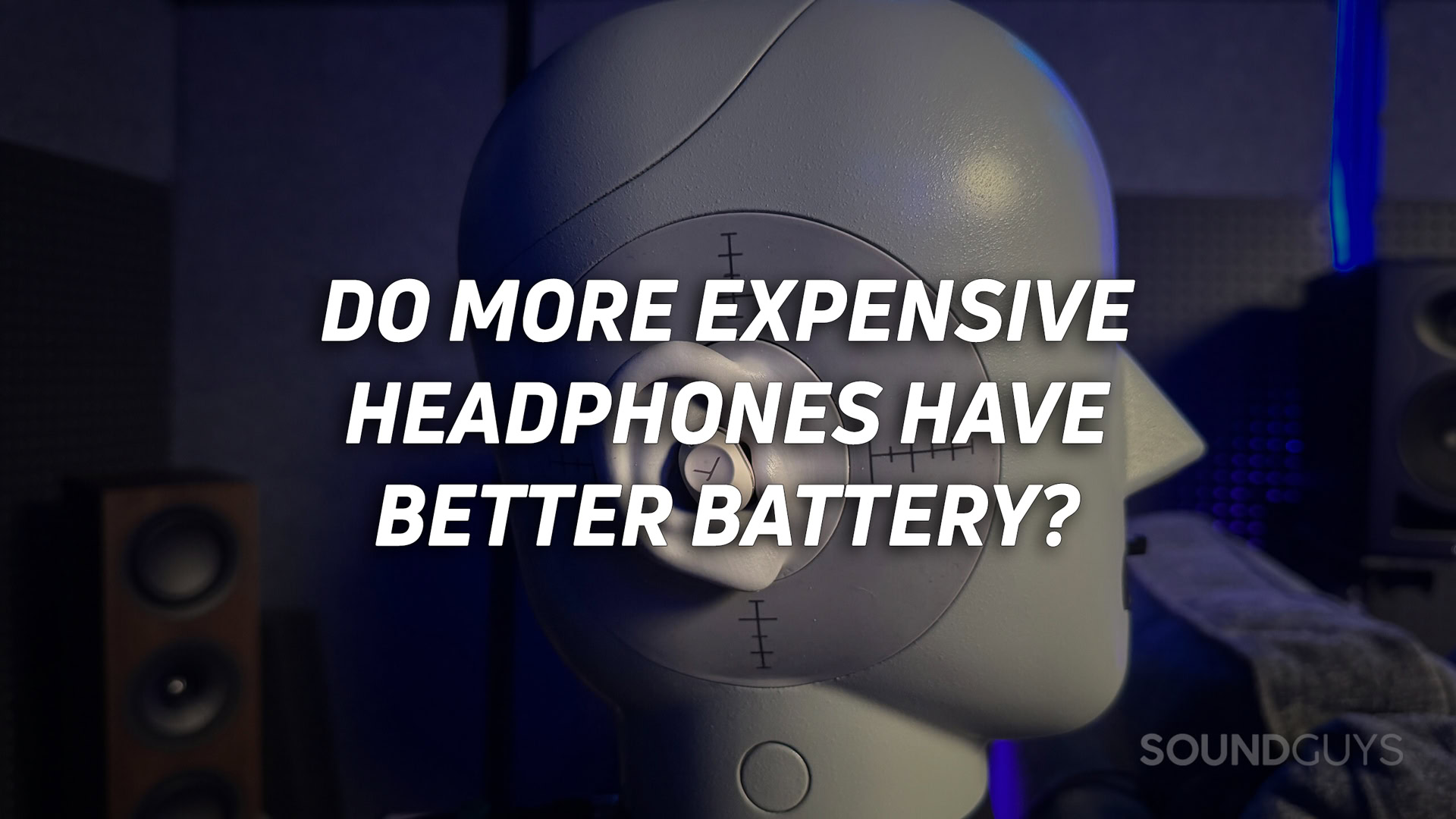 A photo of a test mannequin with earbuds in the ear, with the text "do more expensive headphones have better battery?" overlaid on top in white.