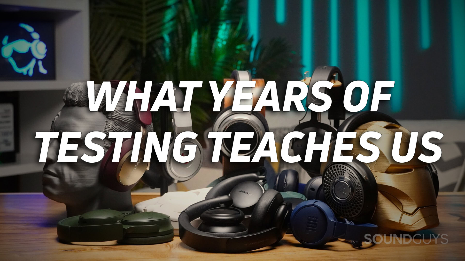 A photo of a large pile of headphones on a desk, with the text "what years of testing teaches us" overlaid in white text.