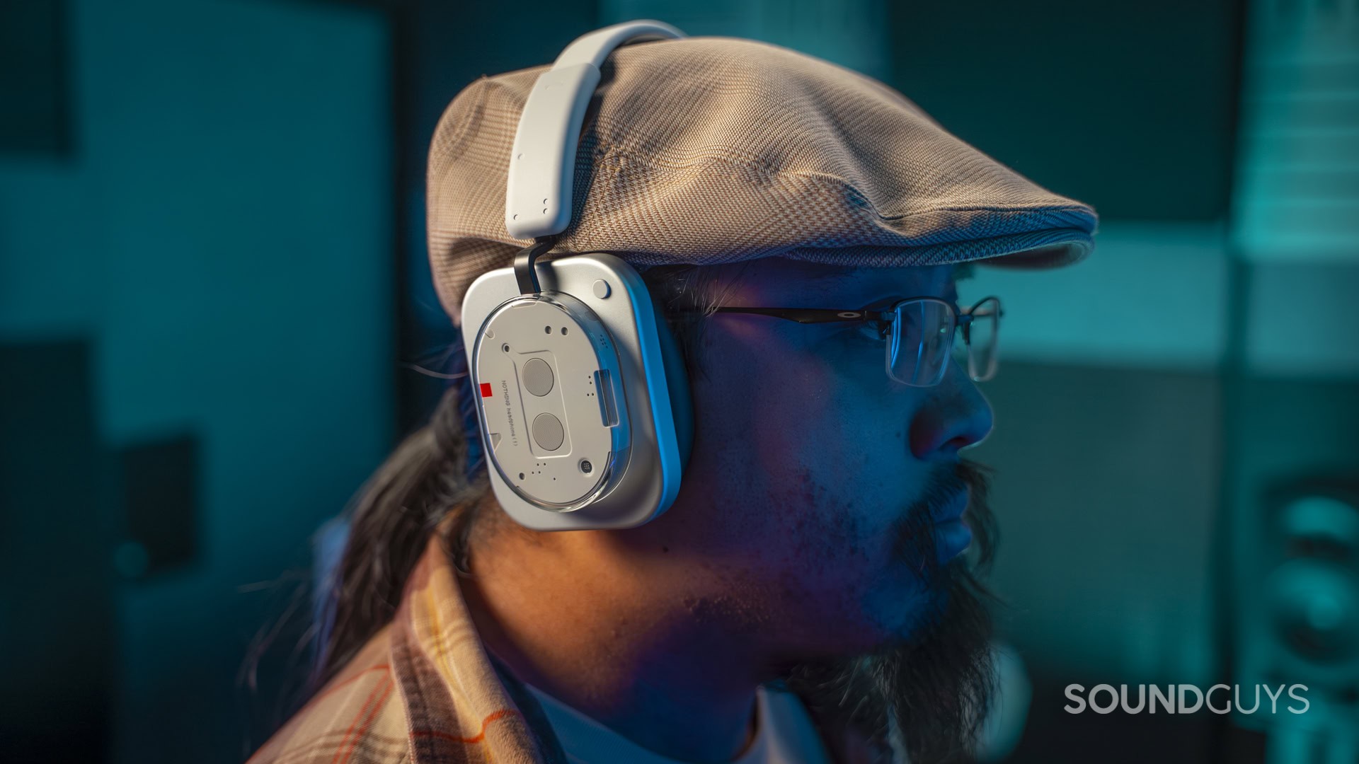 A photo of a man wearing the Nothing Headphone 1 in a dark room.