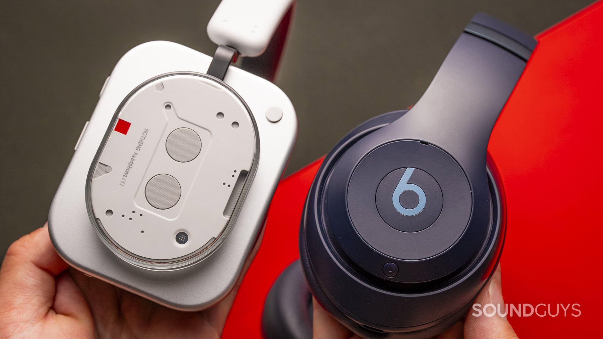 nothing-headphone-1-vs-beats-studio-pro-side-ear cup Nothing Headphone (1) next to Beats Studio Pro showing the logos.