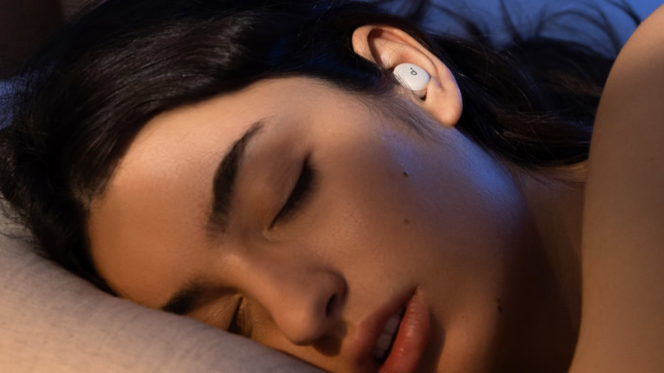 soundcore sleep a30 woman a woman wearing the soundcore sleep a30 earbuds while sleeping