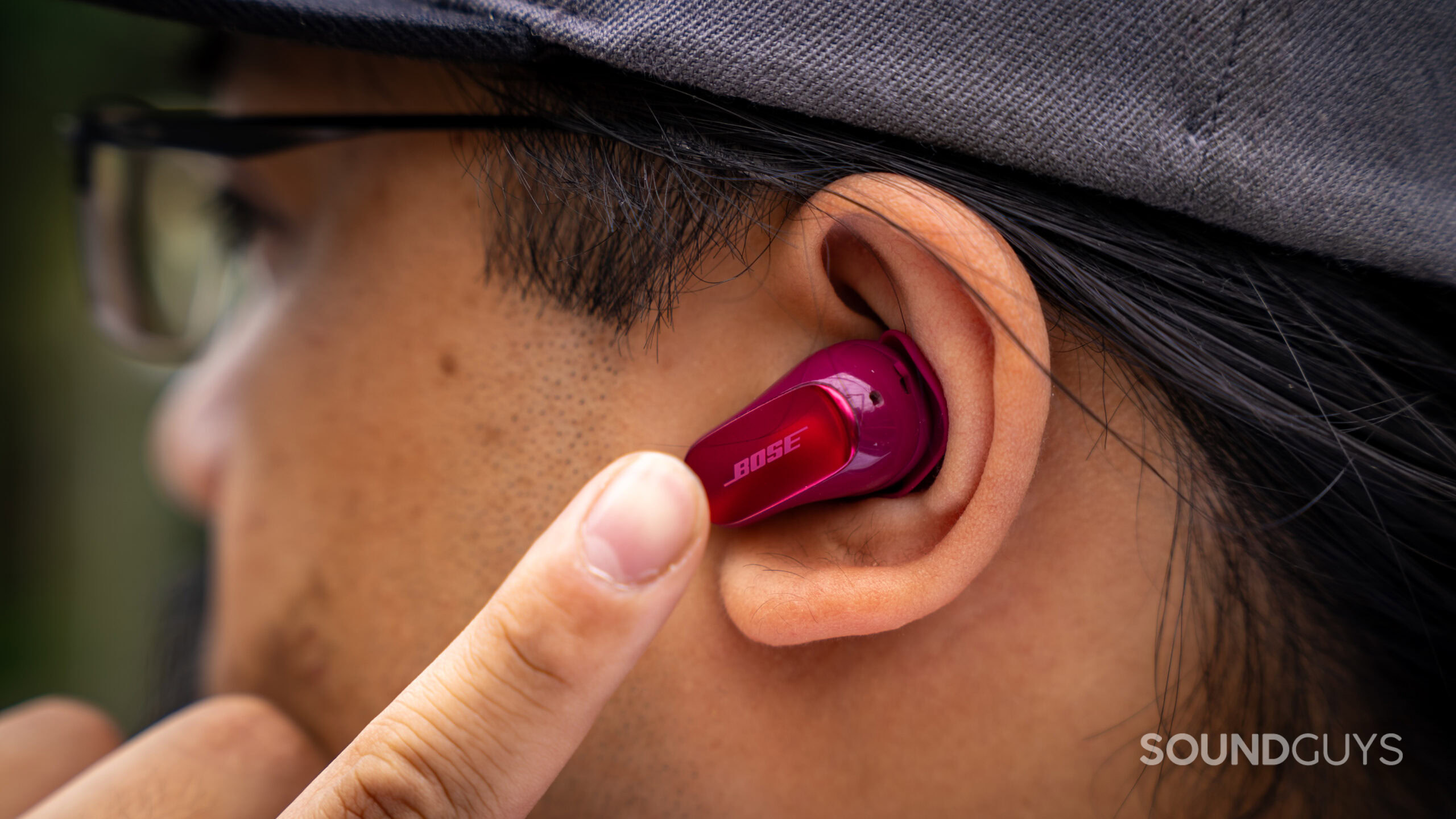 Bose QuietComfort Ultra Earbuds (2nd Gen)_24 A photo of a man using the capacitive touch plates of the Bose QuietComfort Ultra Earbuds (2nd Gen).