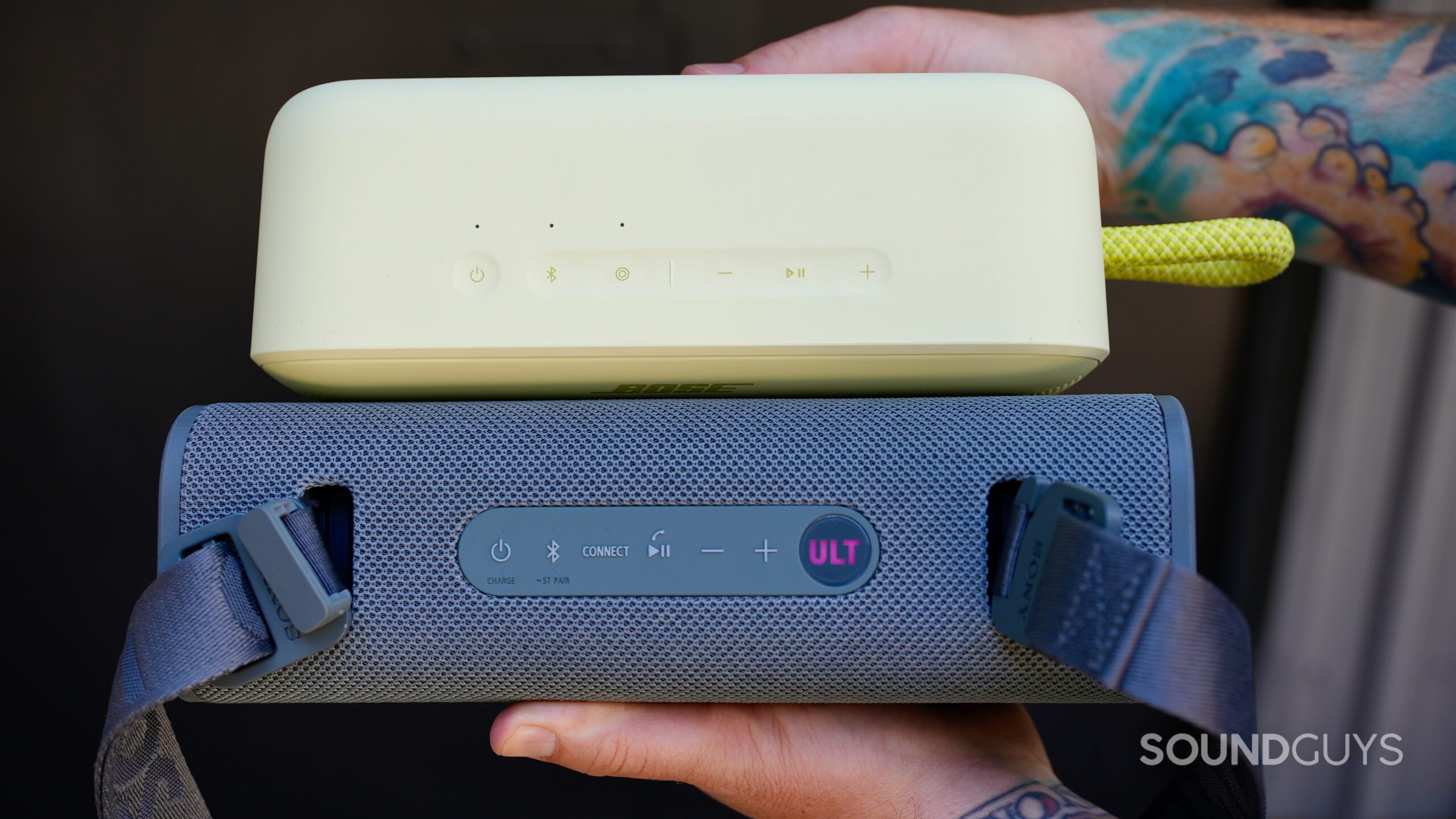 SL Plus Vs ULT Field 3 - 2 A man holding the Bose SoundLink Plus and Sony ULT Field 3 together, showing their size difference.