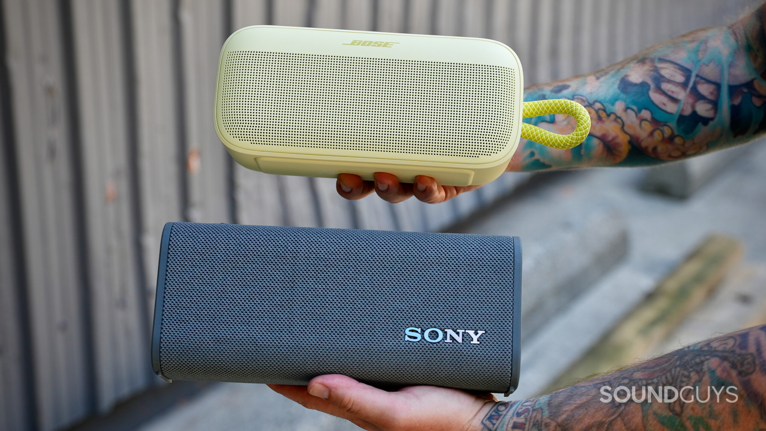 SL Plus Vs ULT Field 3 - 7 A man holding the Bose SoundLink Plus and Sony ULT Field 3 together, showing their size difference.