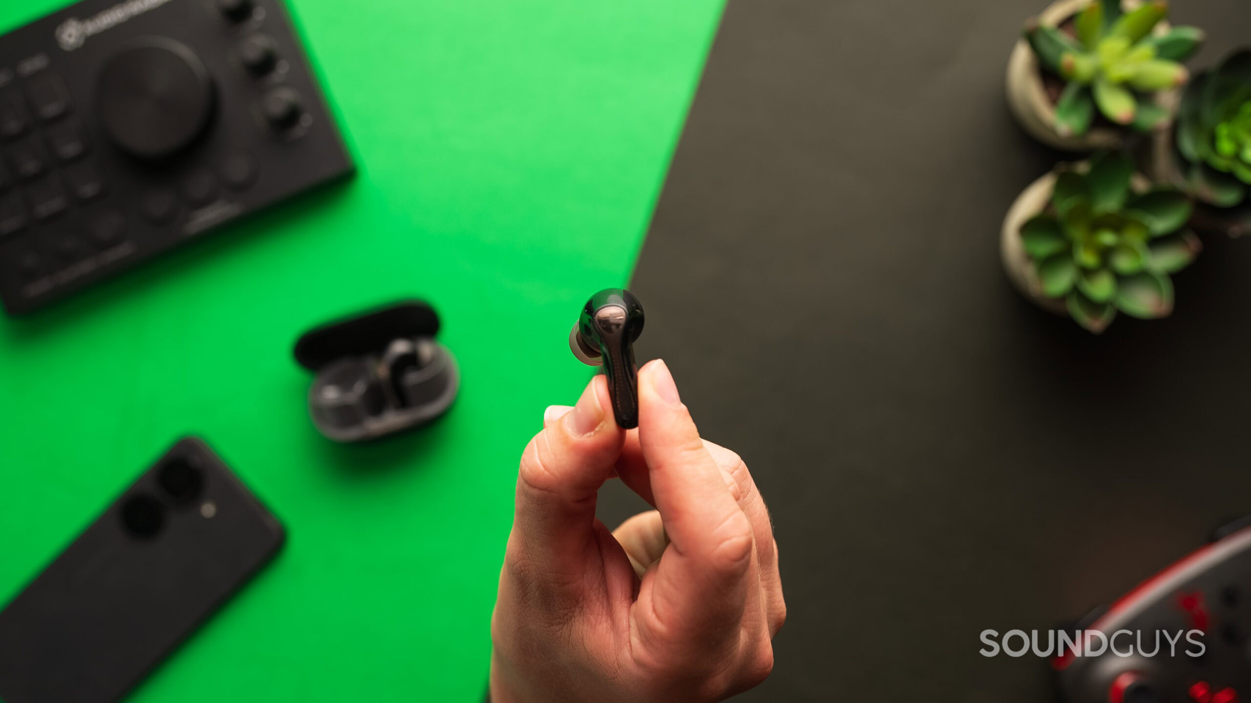 A SOUNDPEATS Air5 Pro earbud held in hand.