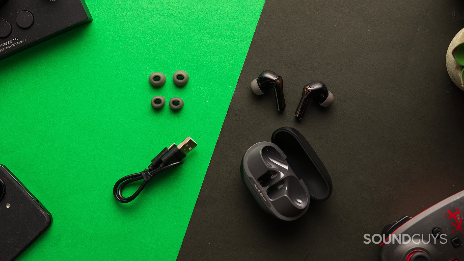 SOUNDPEATS Air5 Pro earbuds on a table with the included accessories. 
