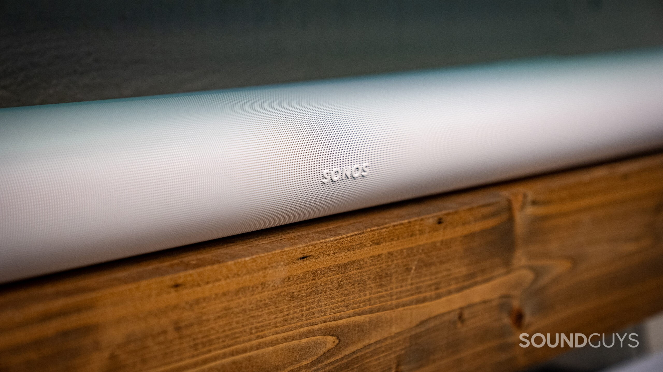 Sonos Arc Ultra + Sub_1 The Sonos Arc Ultra soundbar on a wooden shelf.