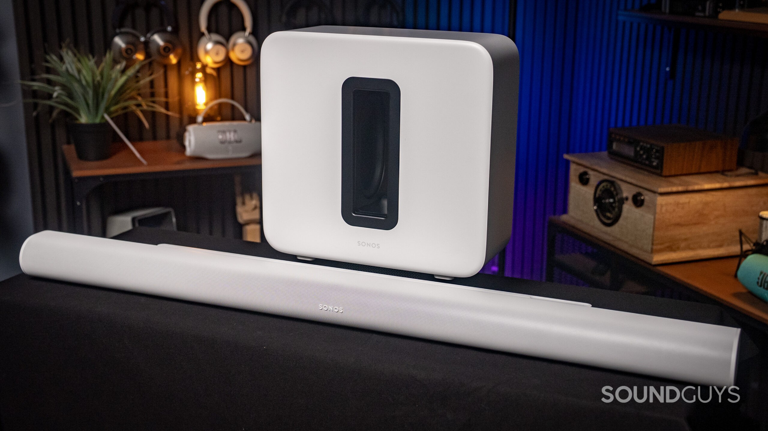 Sonos Arc Ultra + Sub_4 The Sonos Arc Ultra and Sub 4 placed on a workbench in a nice room.