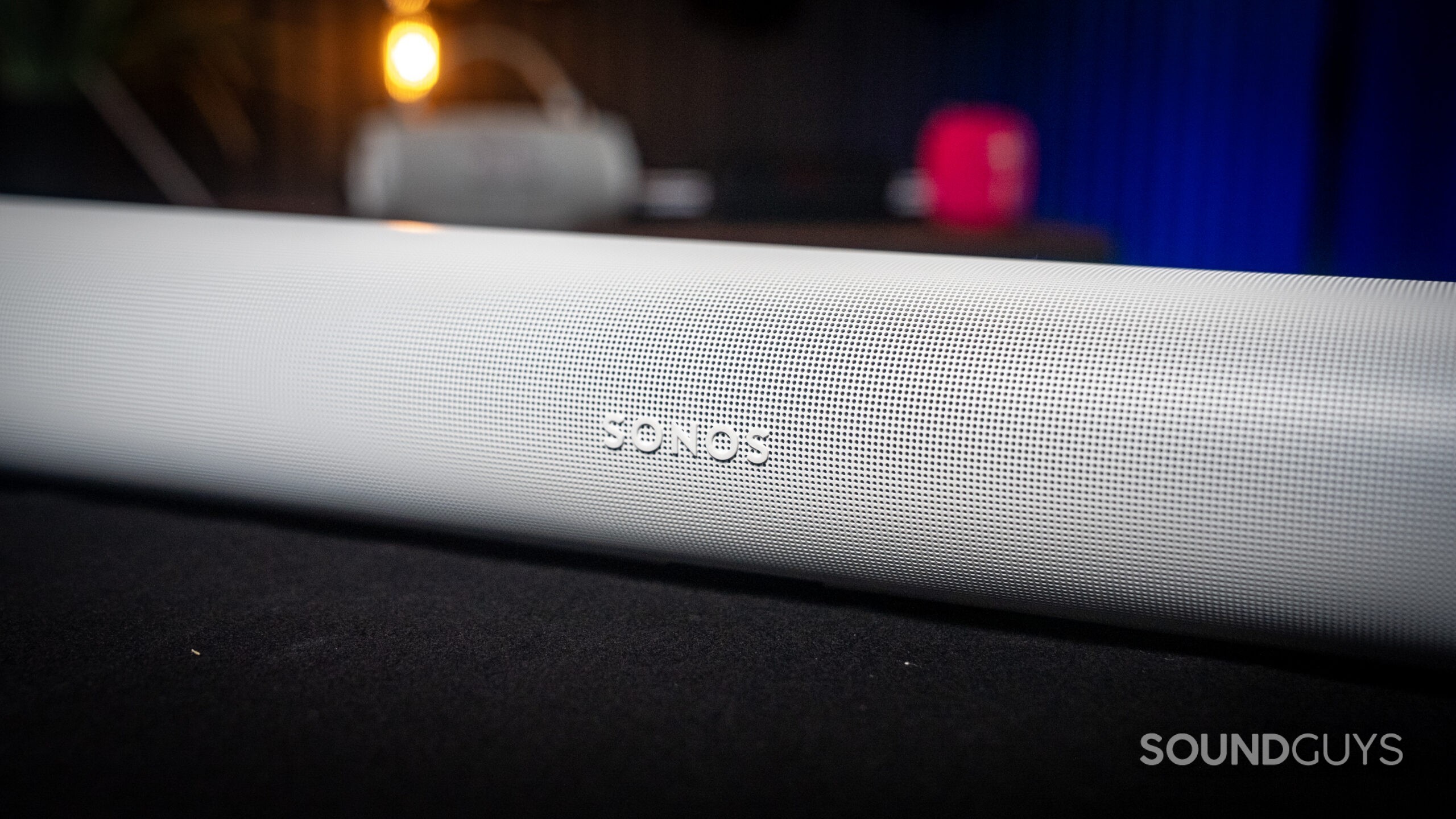 Sonos Arc Ultra + Sub_7 The Sonos Arc Ultra soundbar on a black shelf.